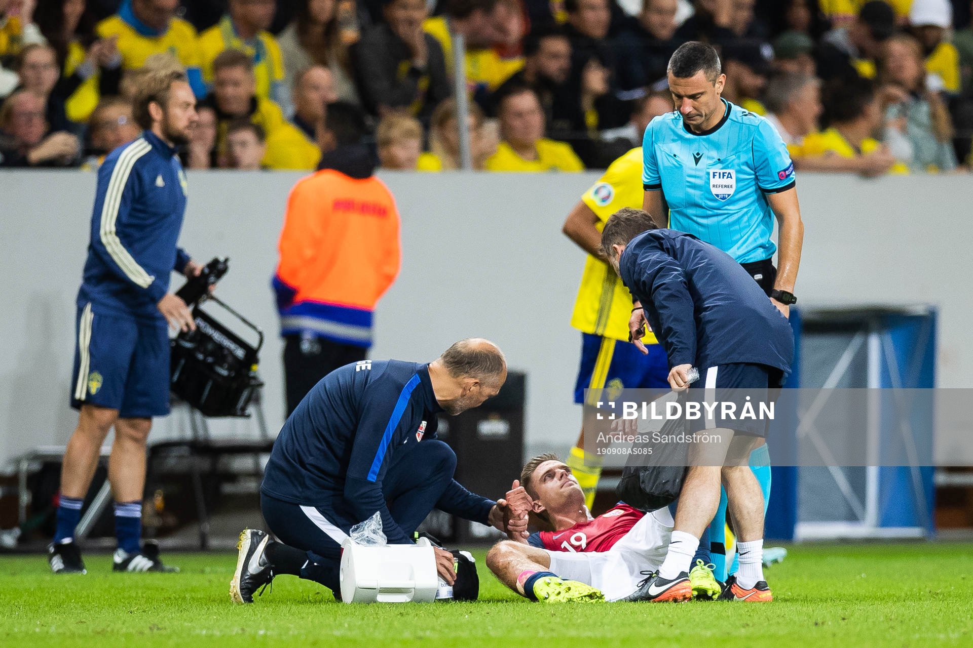 Markus Henriksen of Norway gets medical attention due to