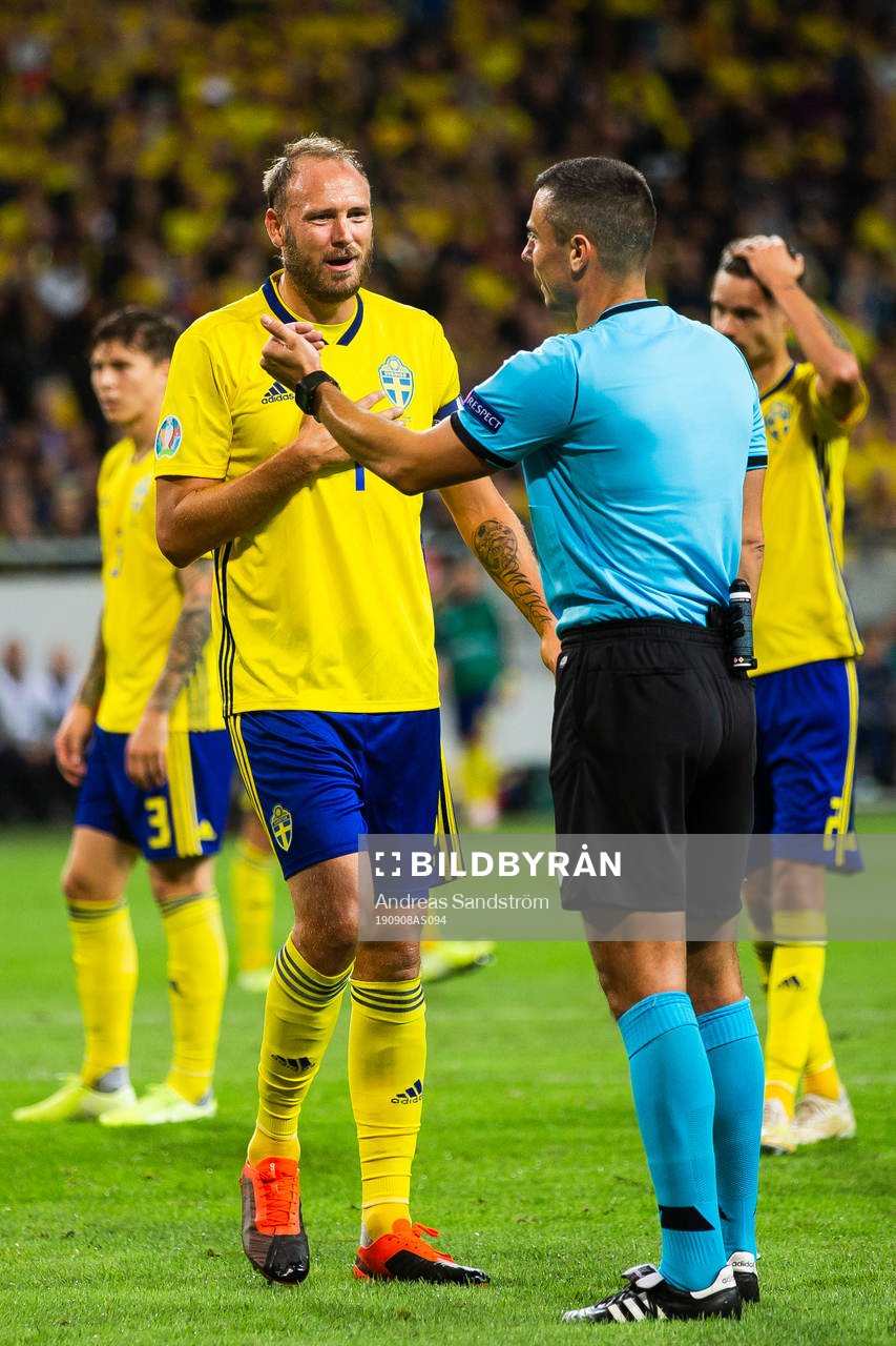 Andreas Granqvist of Sweden in discussion with referee