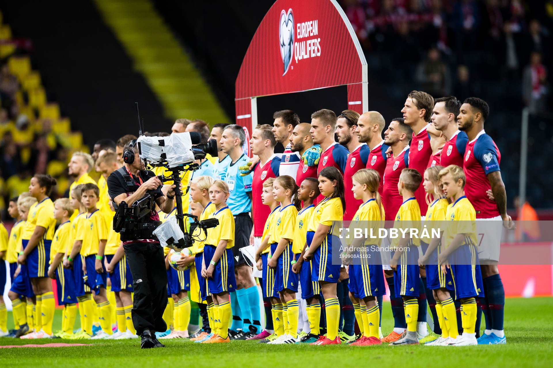 Mascots infront of the players at the line-up