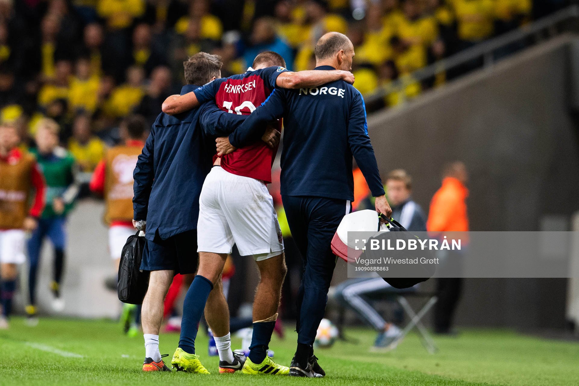 Markus Henriksen of Norway receives help leaving the pitch