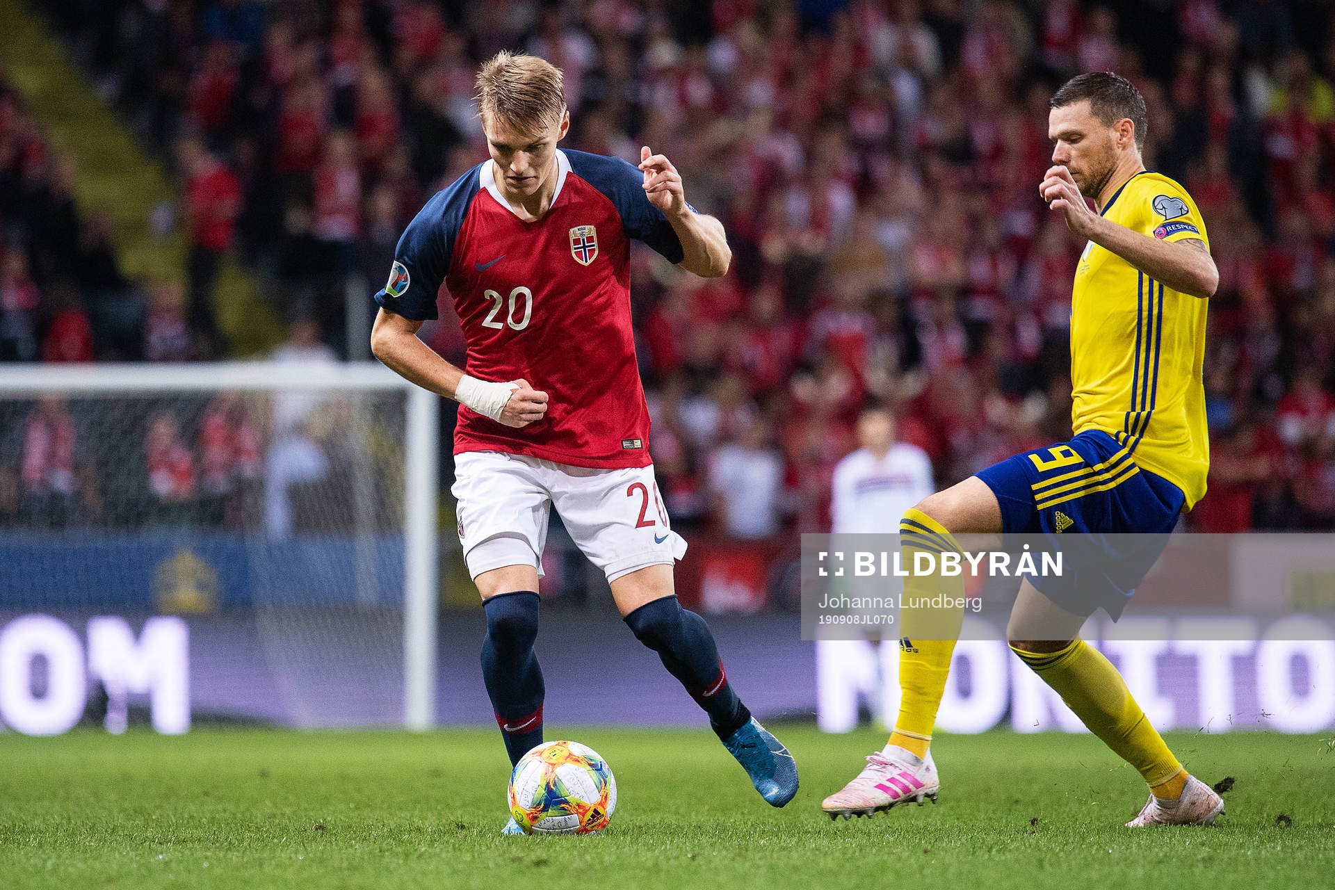 Martin Ødegaard of Norway and Marcus Berg of Sweden