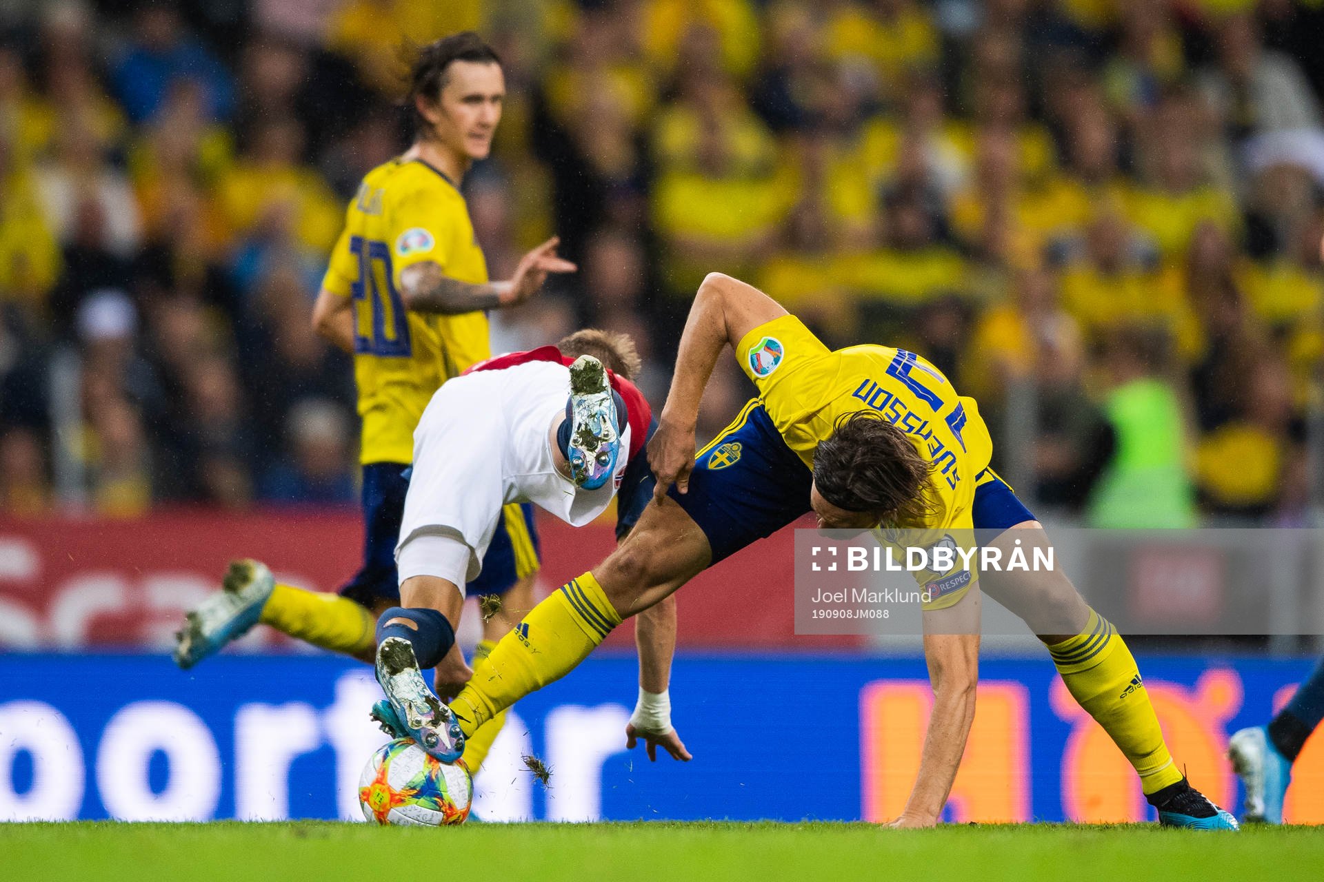 Martin Ødegaard of Norway falls over Gustav Svensson of