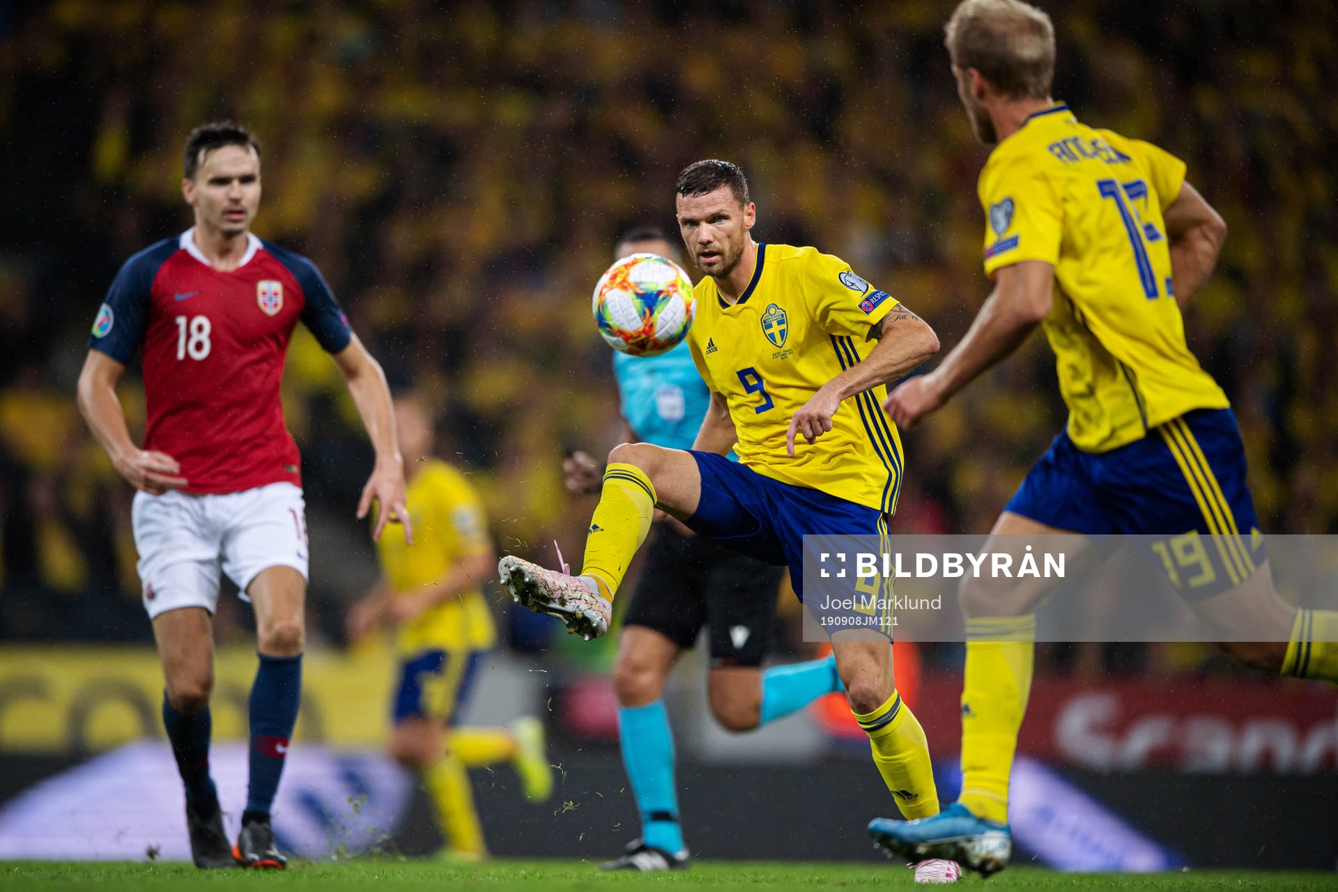Marcus Berg of Sweden passes the ball to Sebastian Andersson