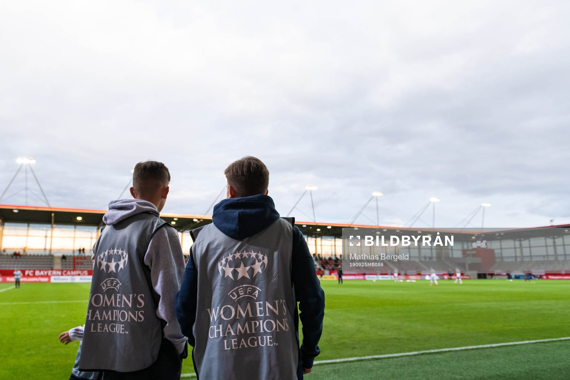 Two boys wearing UEFA Women’s Champions League vests
