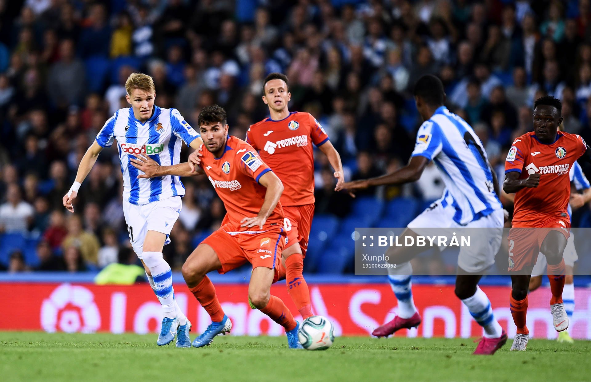 Martin Odegaard of Real Sociedad battles for the ball with