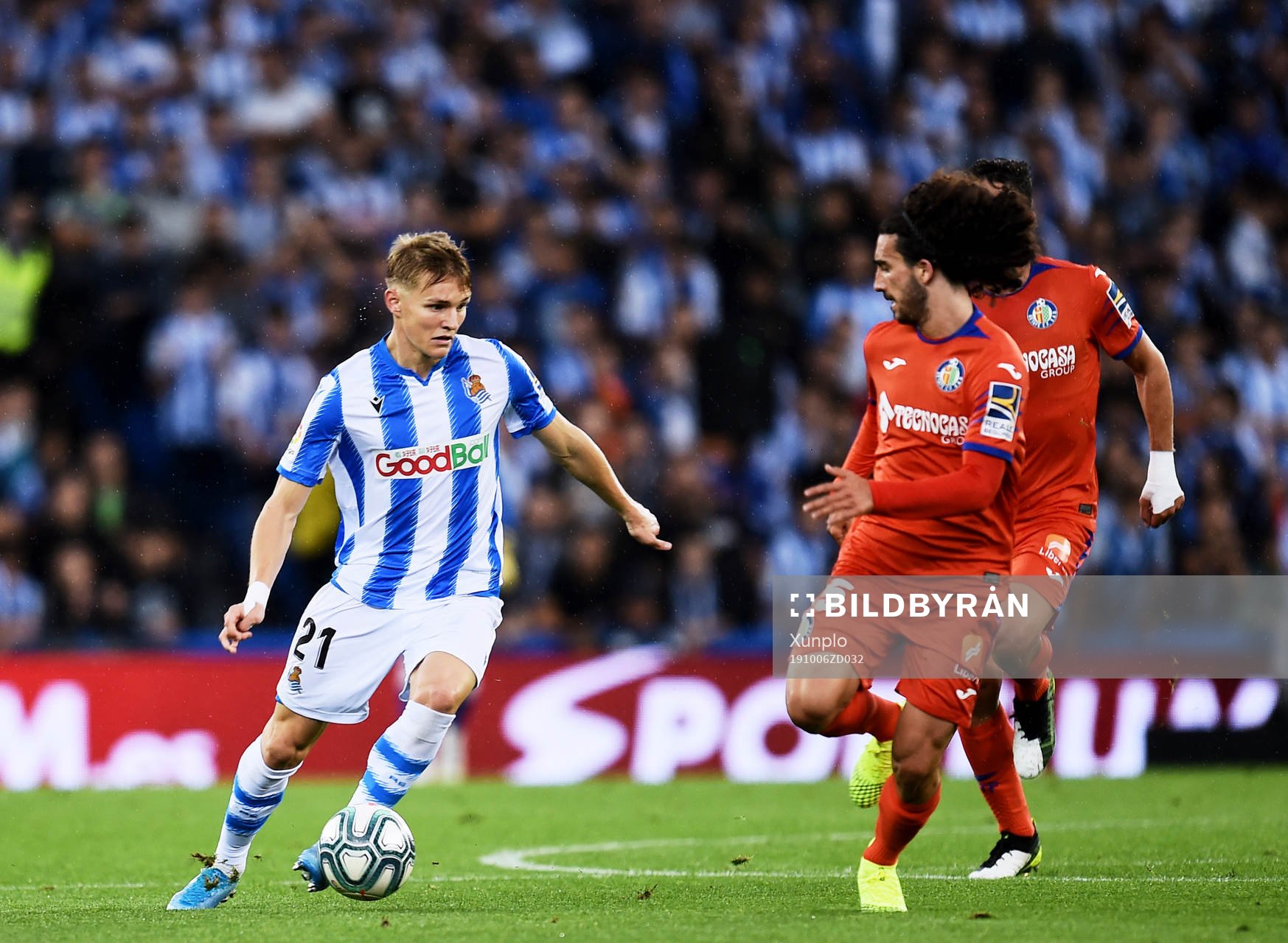 Martin Odegaard of Real Sociedad battles for the ball with