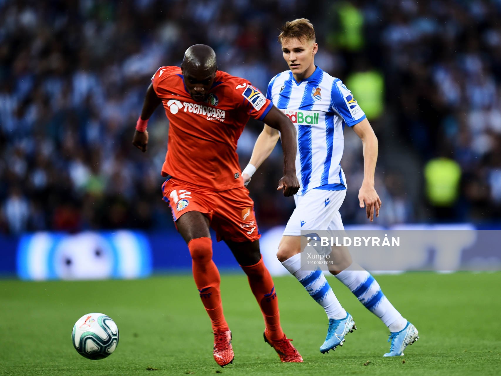 Martin Odegaard of Real Sociedad battles for the ball with