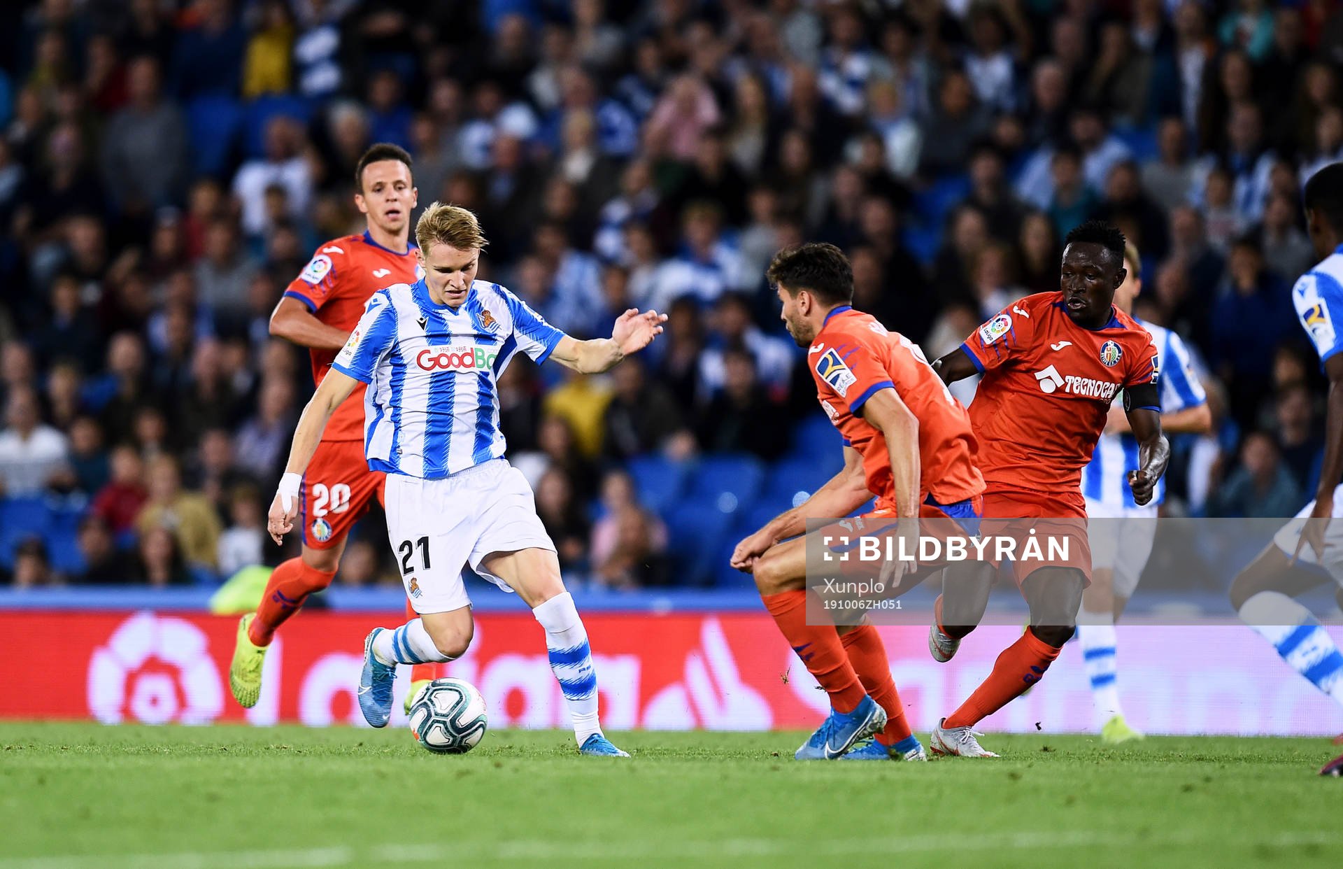 Martin Odegaard of Real Sociedad battles for the ball with