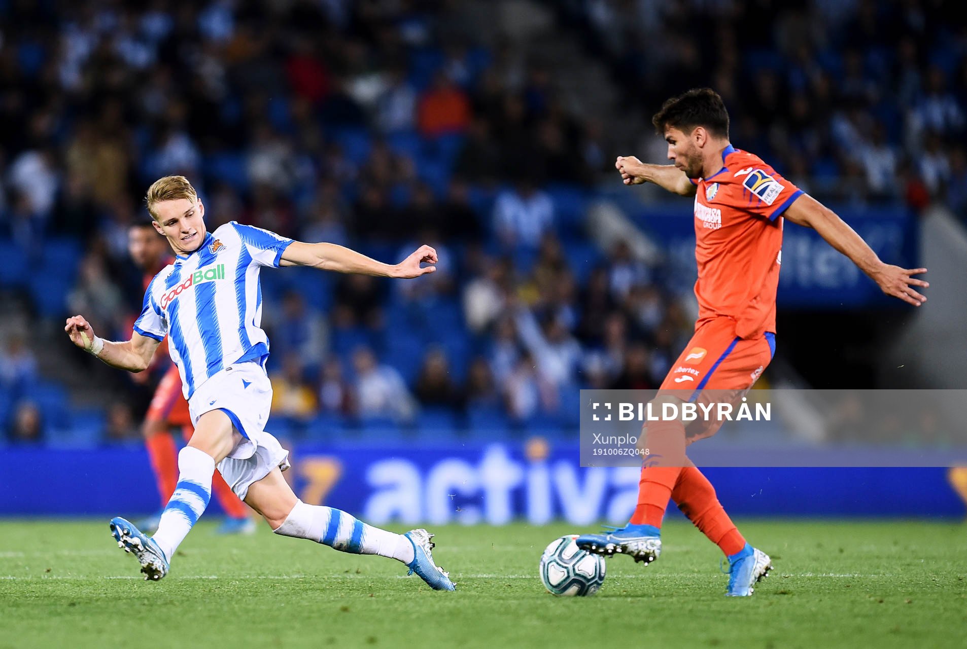 Martin Odegaard of Real Sociedad battles for the ball with