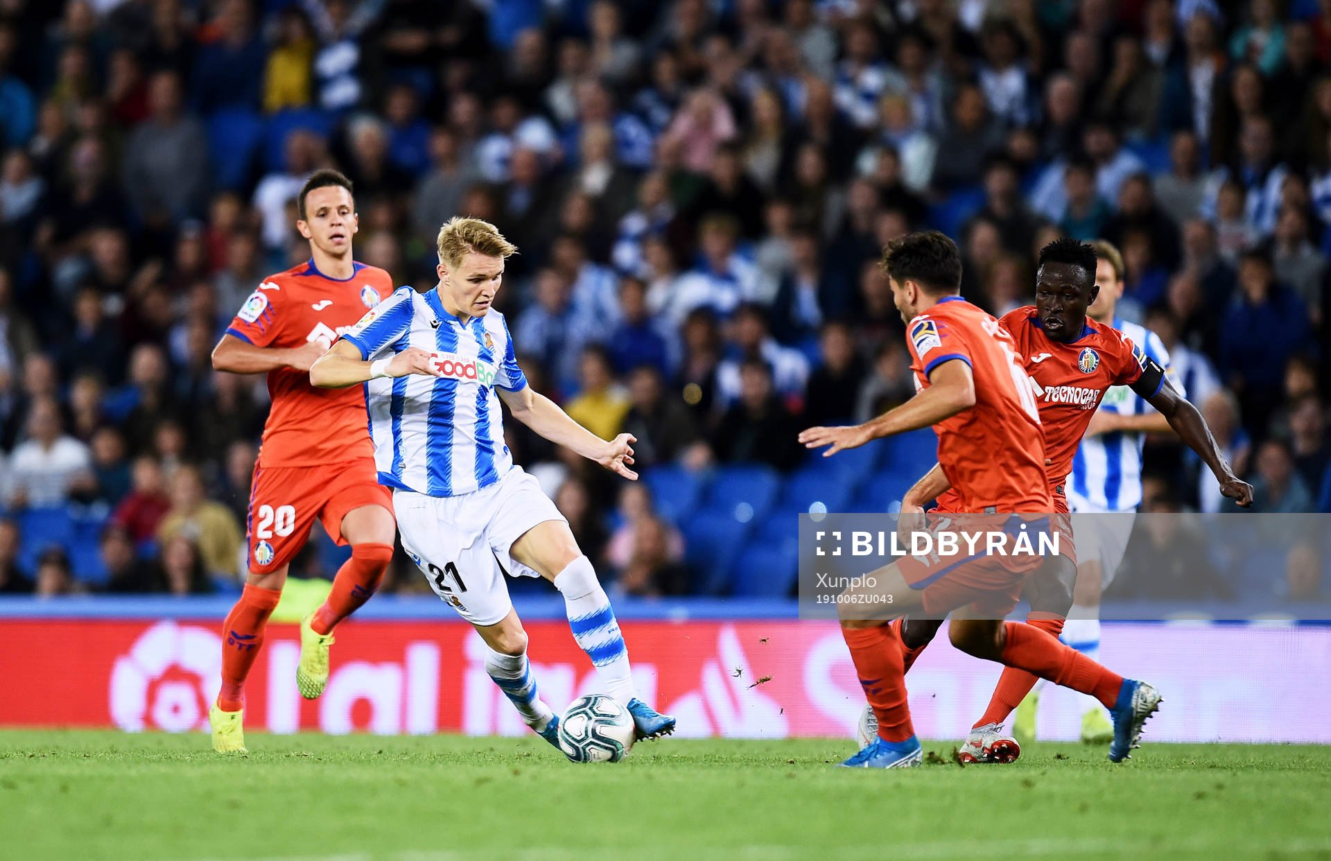 Martin Odegaard of Real Sociedad battles for the ball with