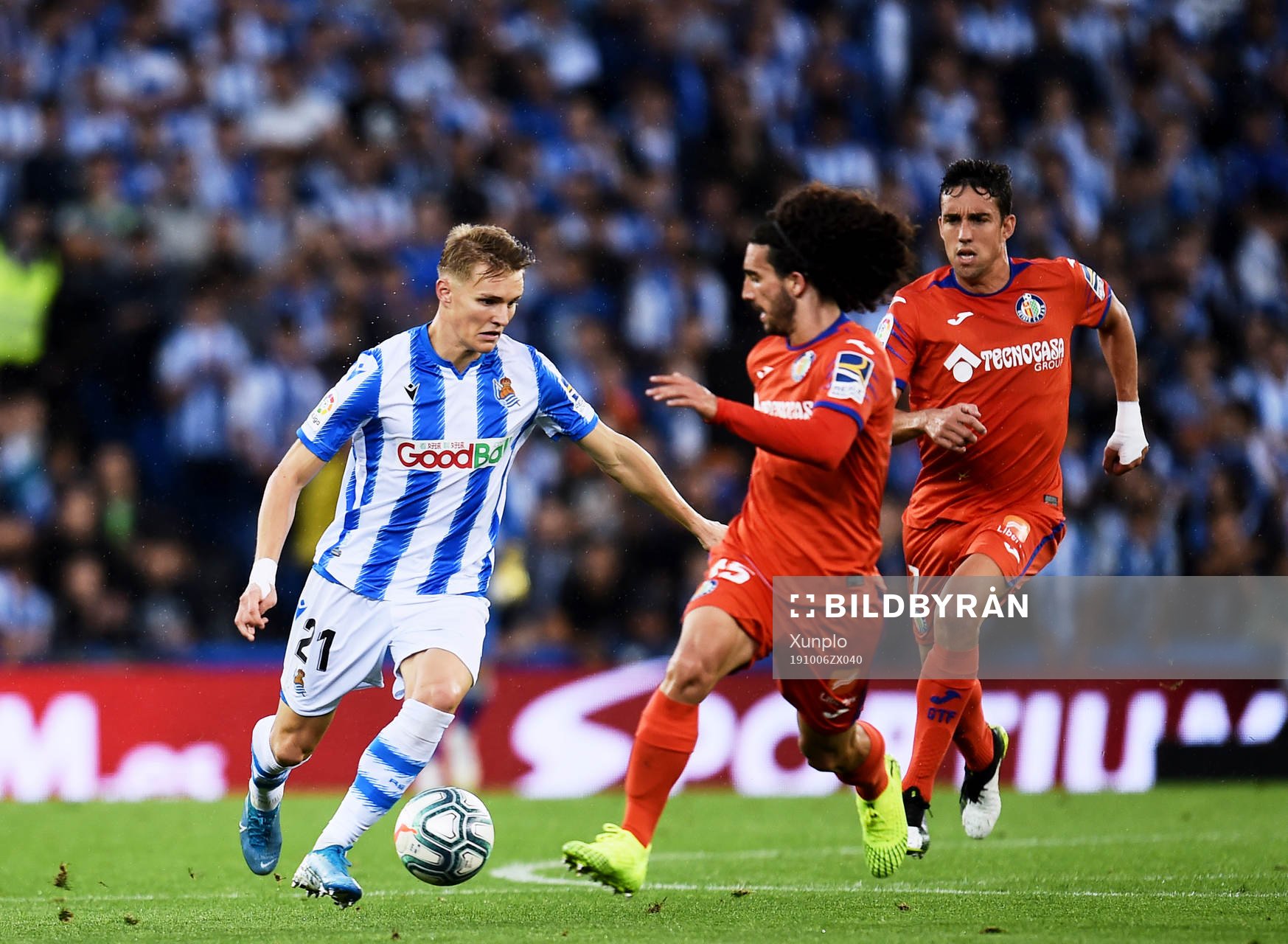 Martin Odegaard of Real Sociedad battles for the ball with