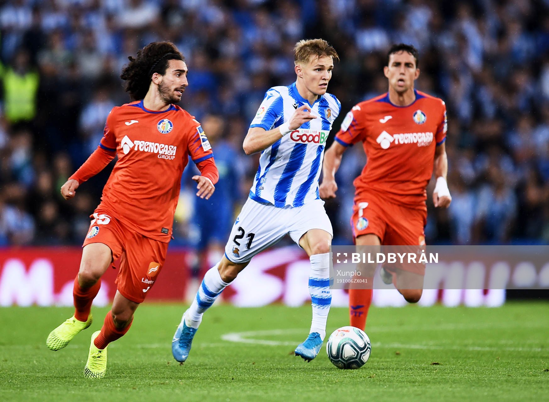 Martin Odegaard of Real Sociedad battles for the ball with
