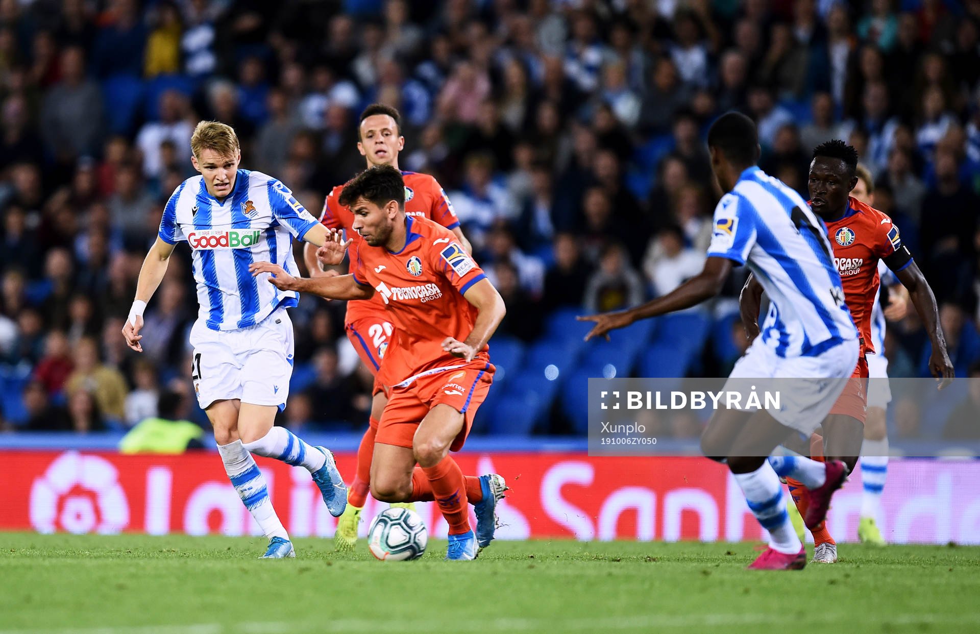 Martin Odegaard of Real Sociedad battles for the ball with
