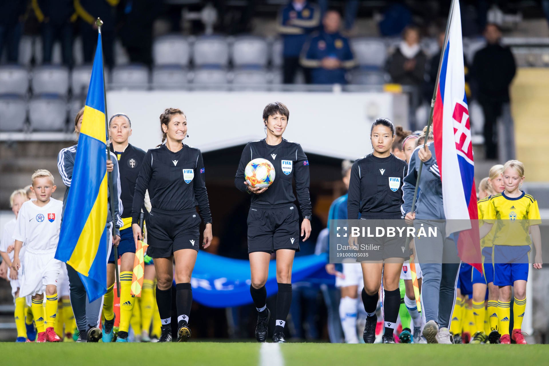 Referee Elvira Nurmustafina walks into the pitch together
