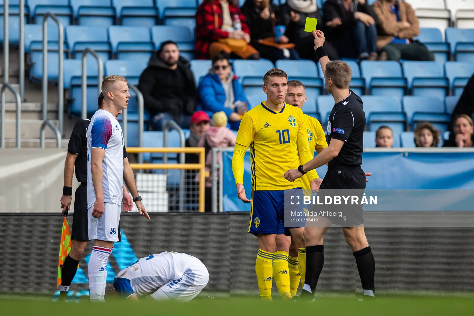 Viktor Gyökeres of Sweden is shown a warning from referee