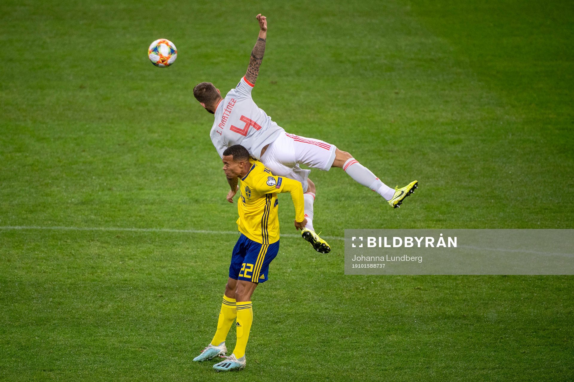 Robin Quaison of Sweden and Inigo Martinez of Spain