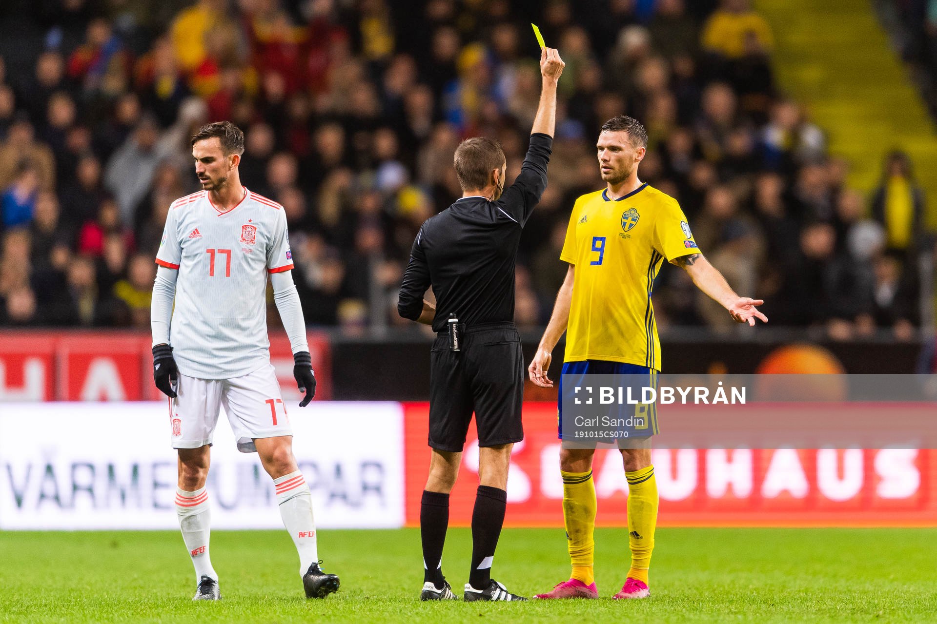 Marcus Berg of Sweden receives a yellow card from referee