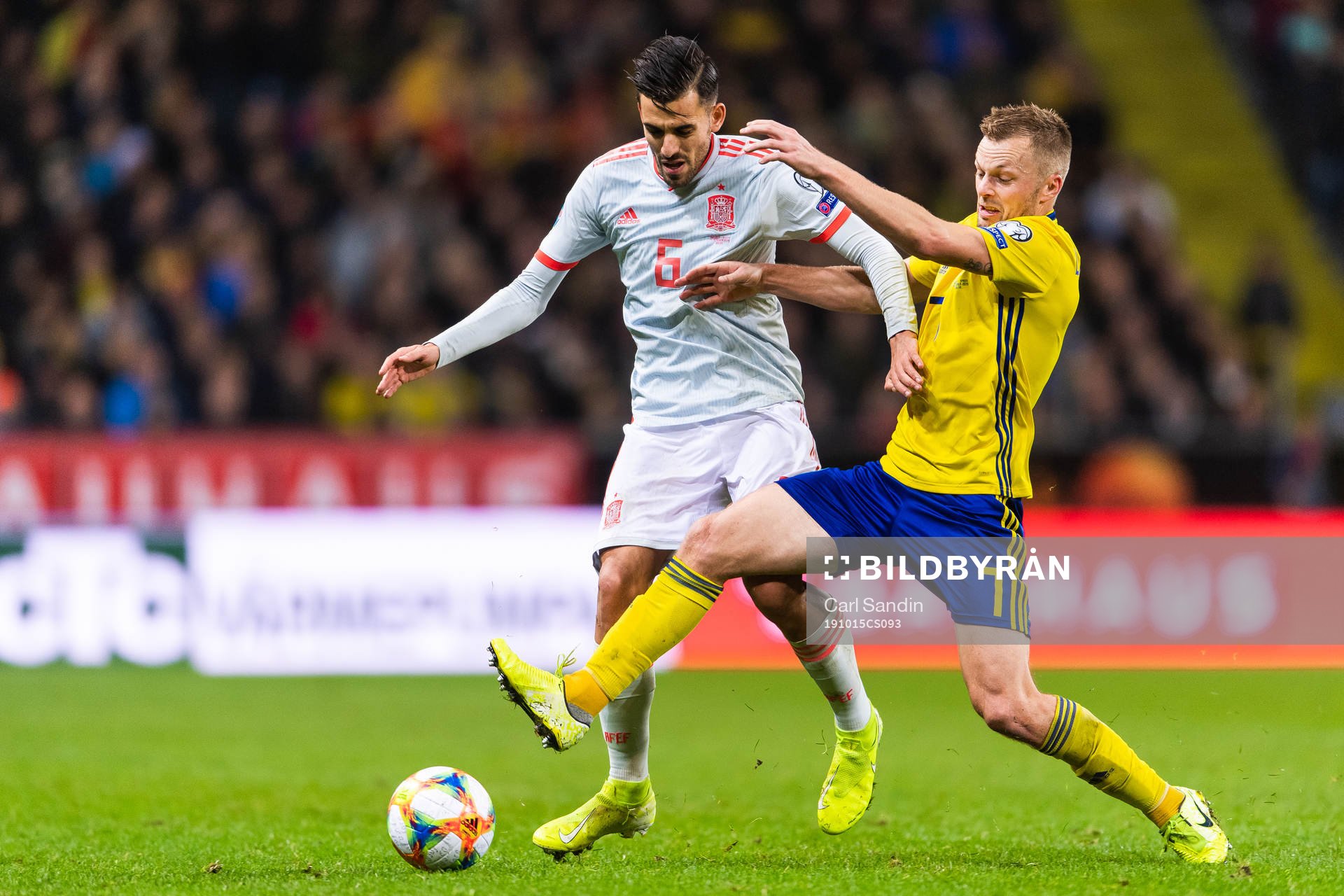 Sergio Busquets of Spain and Sebastian Larsson of Sweden