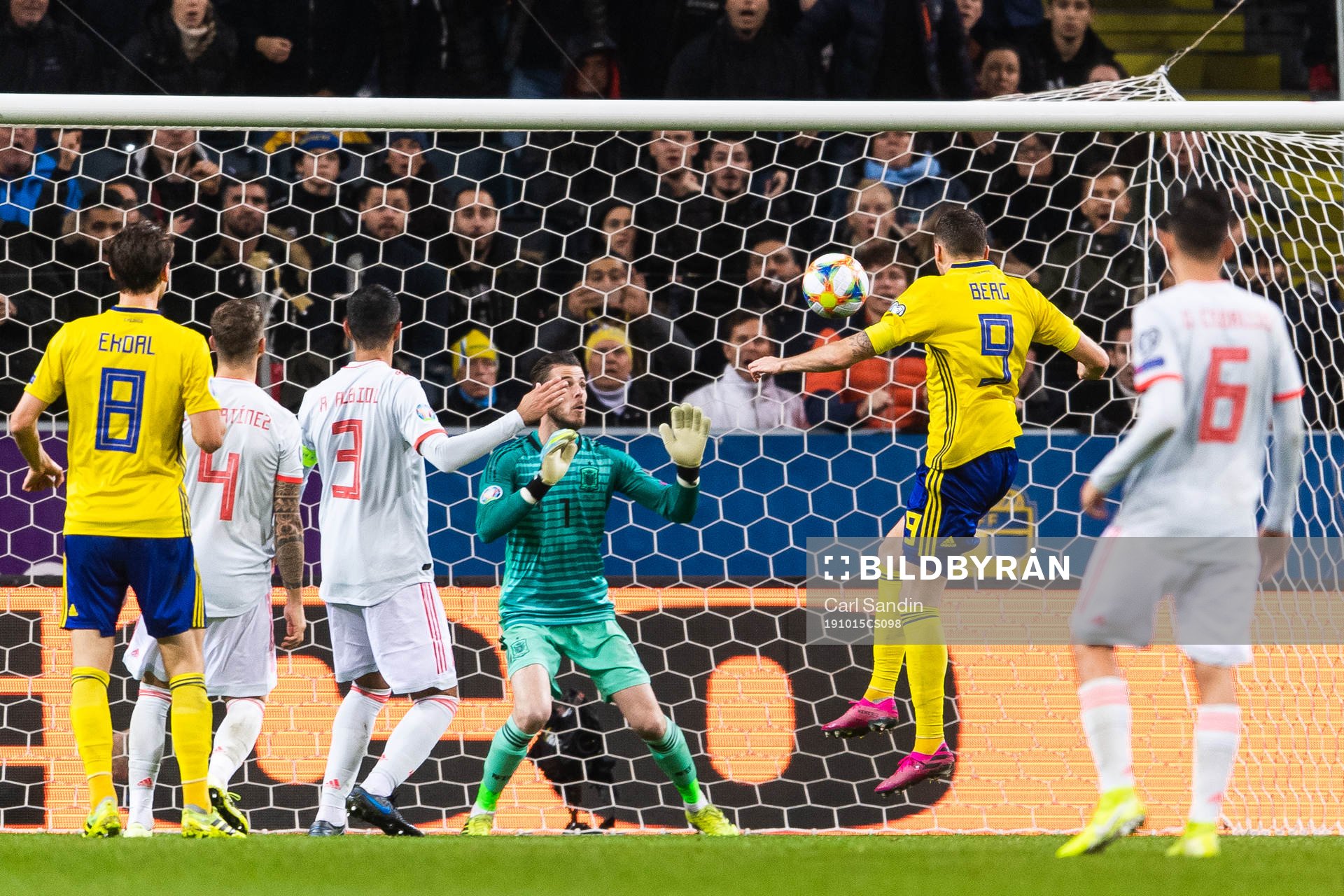 Marcus Berg of Sweden scores 1-0 behind goalkeeper David de