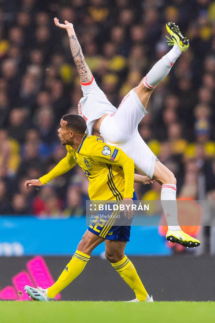 Robin Quaison of Sweden and Inigo Martinez of Spain compete