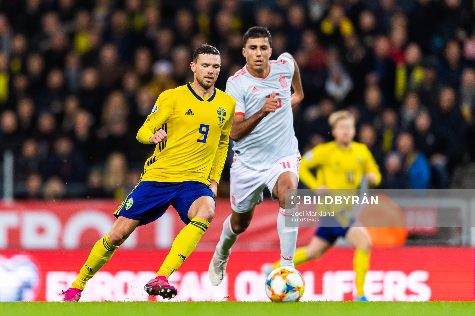 Marcus Berg of Sweden and Rodri of Spain compete for the
