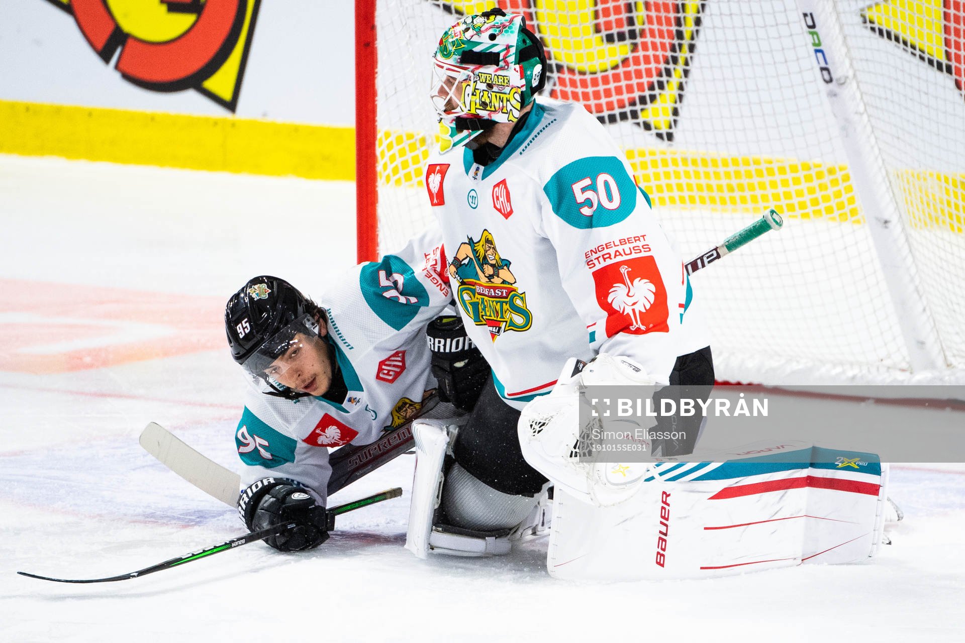 Patryk Wronka and goalkeeper Shane Owen of Belfast looks