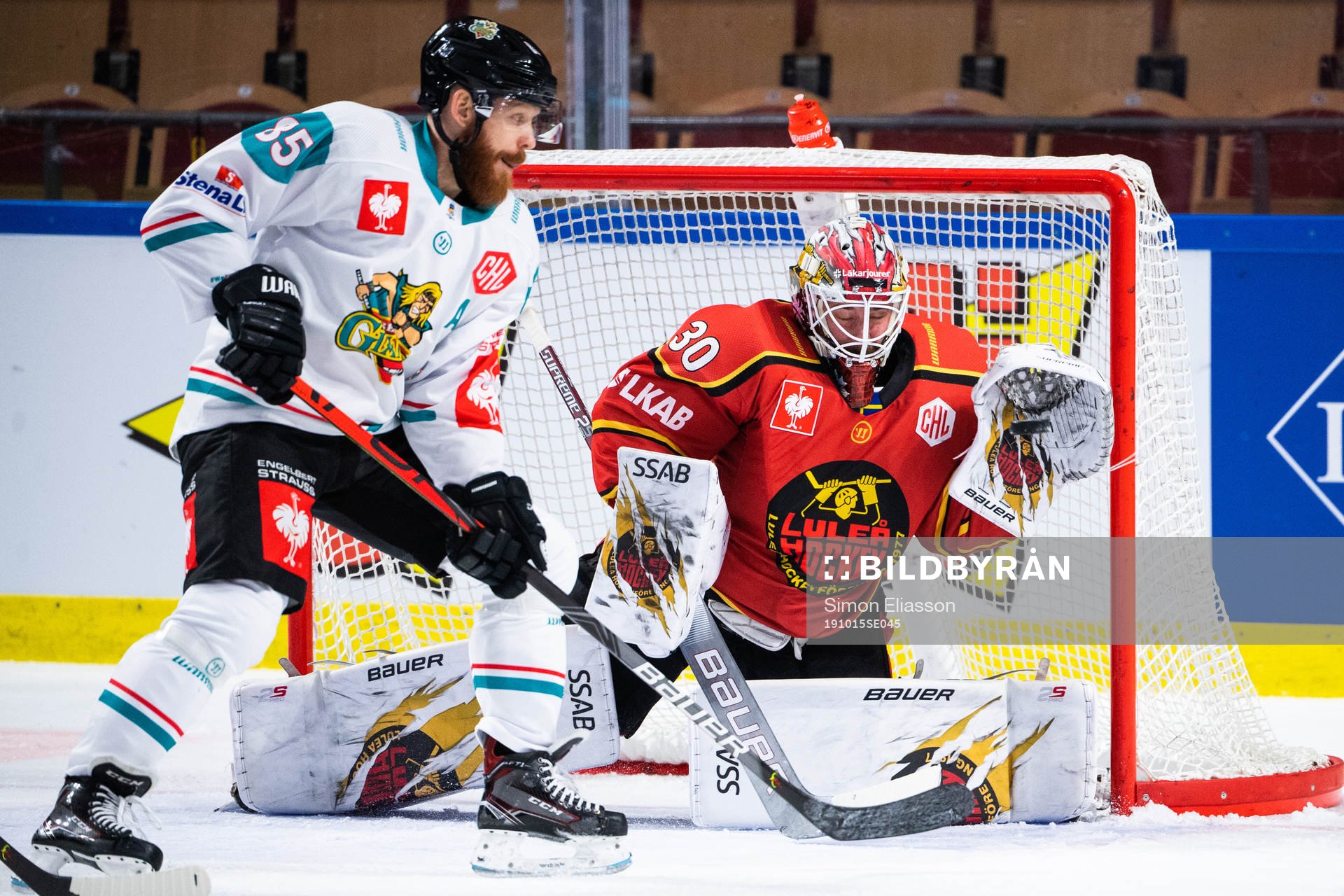 Liam Reddox of Belfast and goalkeeper David Rautio of Luleå