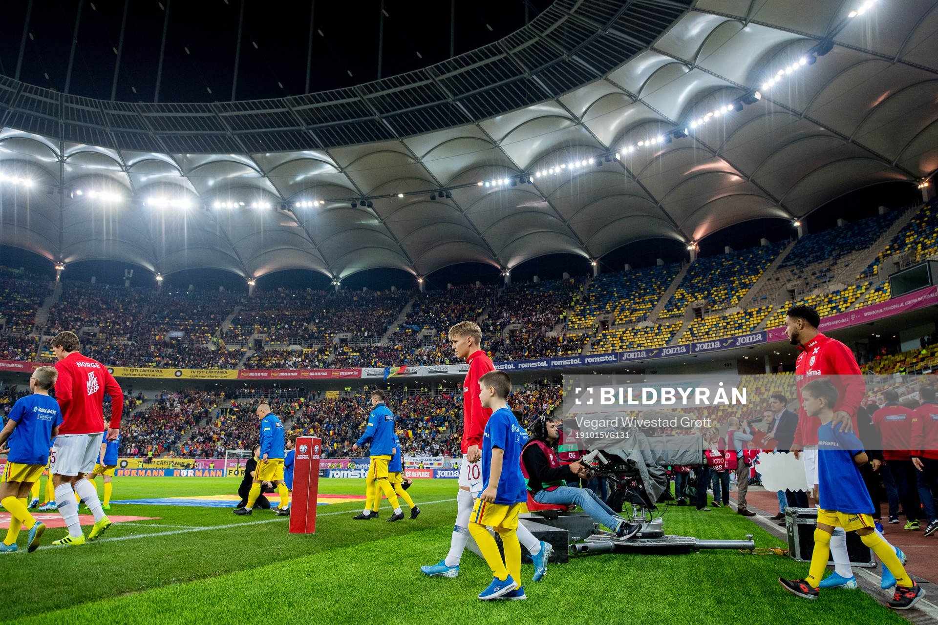 Martin Ødegaard and Joshua King of Norway enter the pitch