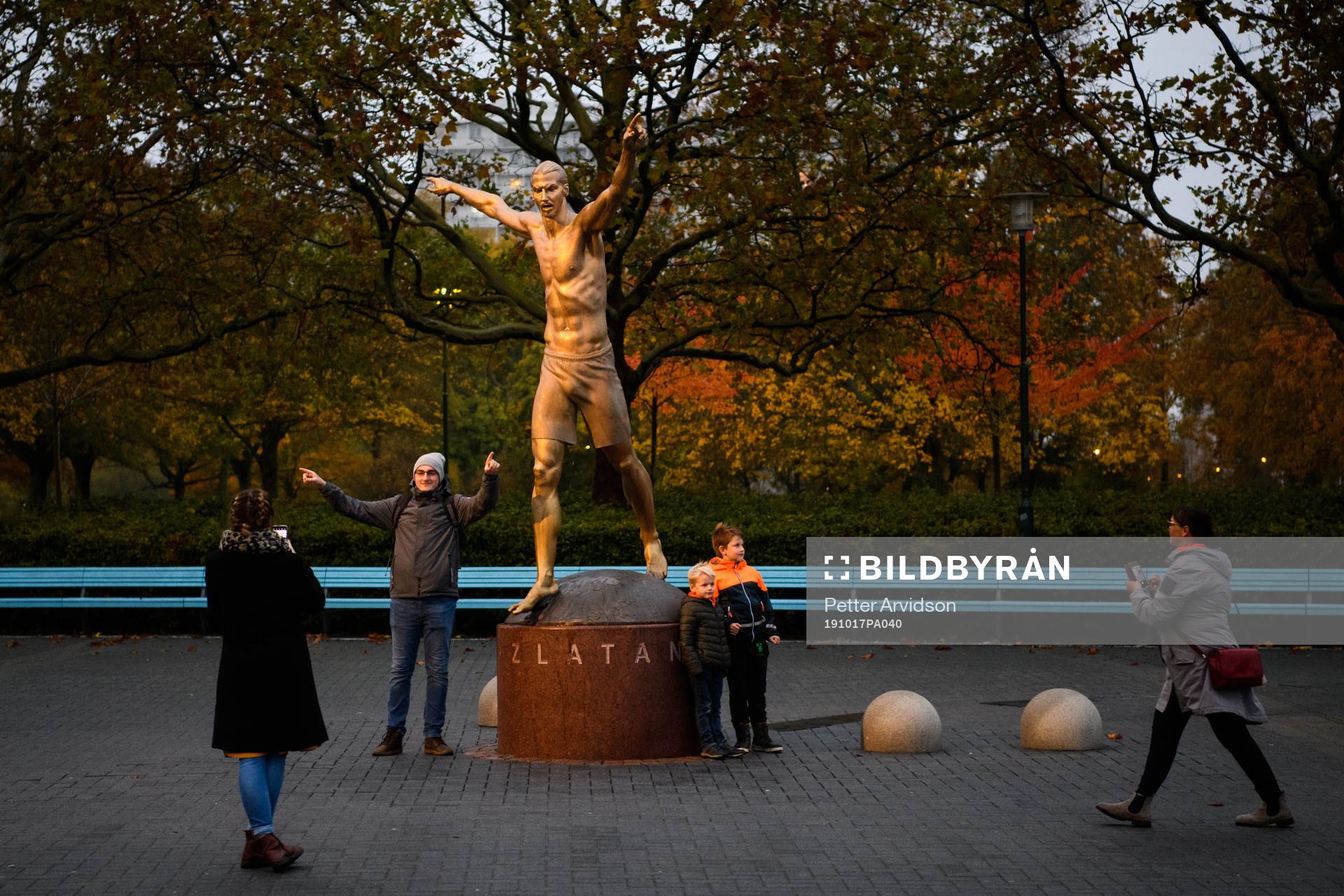 People take pictures with the statue of Zlatan Ibrahimovic