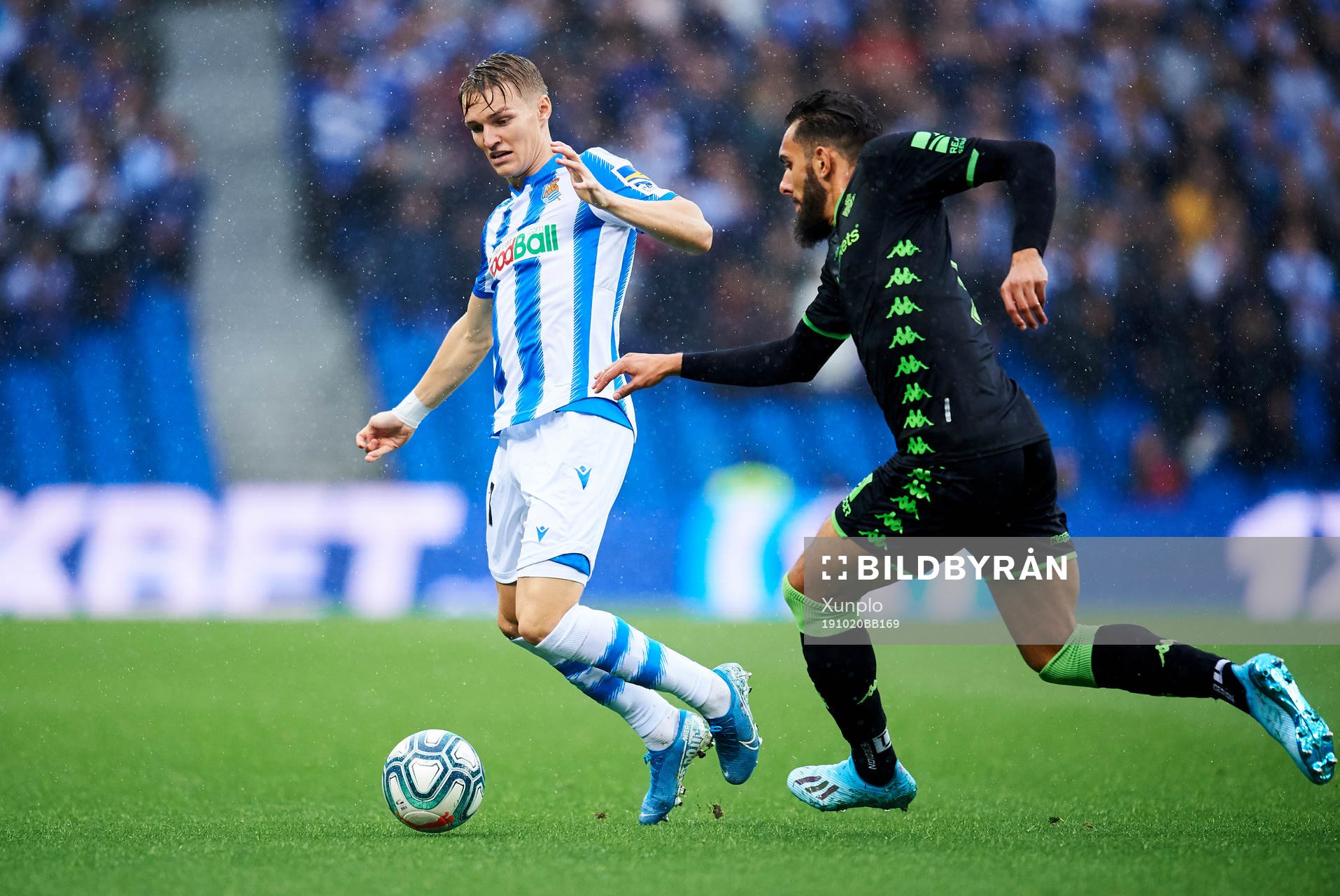 Martin Odegaard of Real Sociedad battles for the ball with