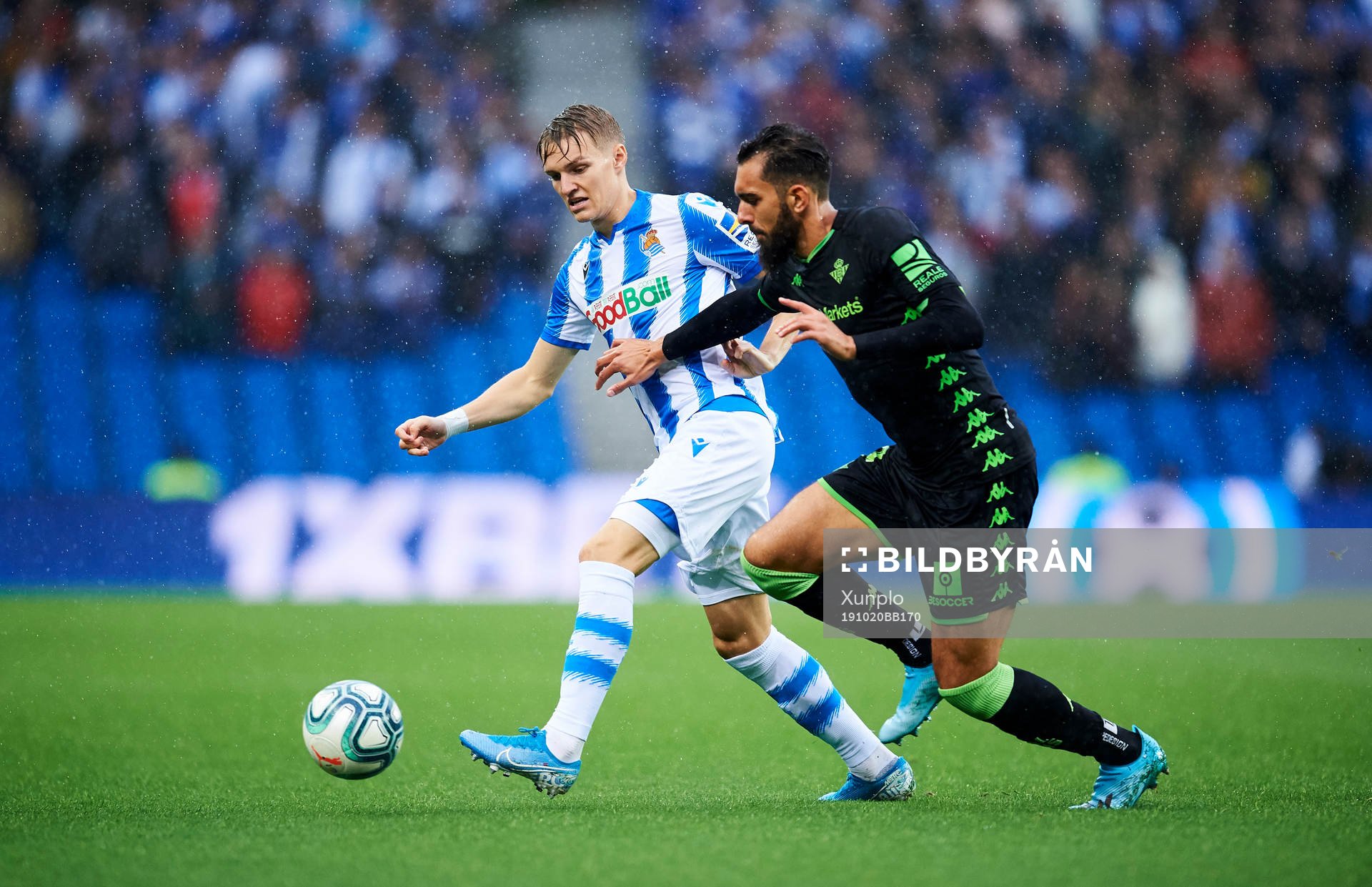 Martin Odegaard of Real Sociedad battles for the ball with