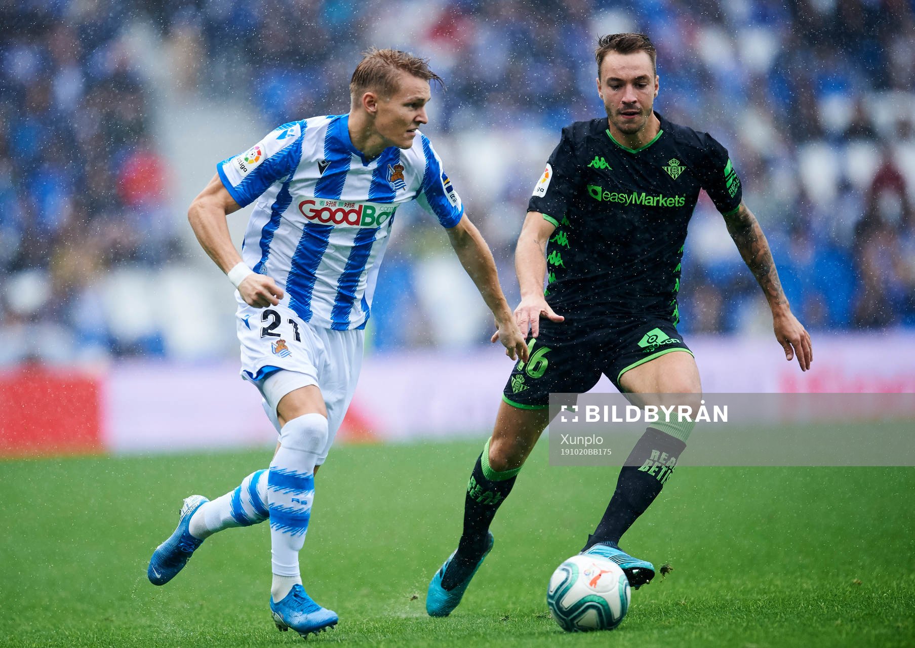 Martin Odegaard of Real Sociedad battles for the ball with