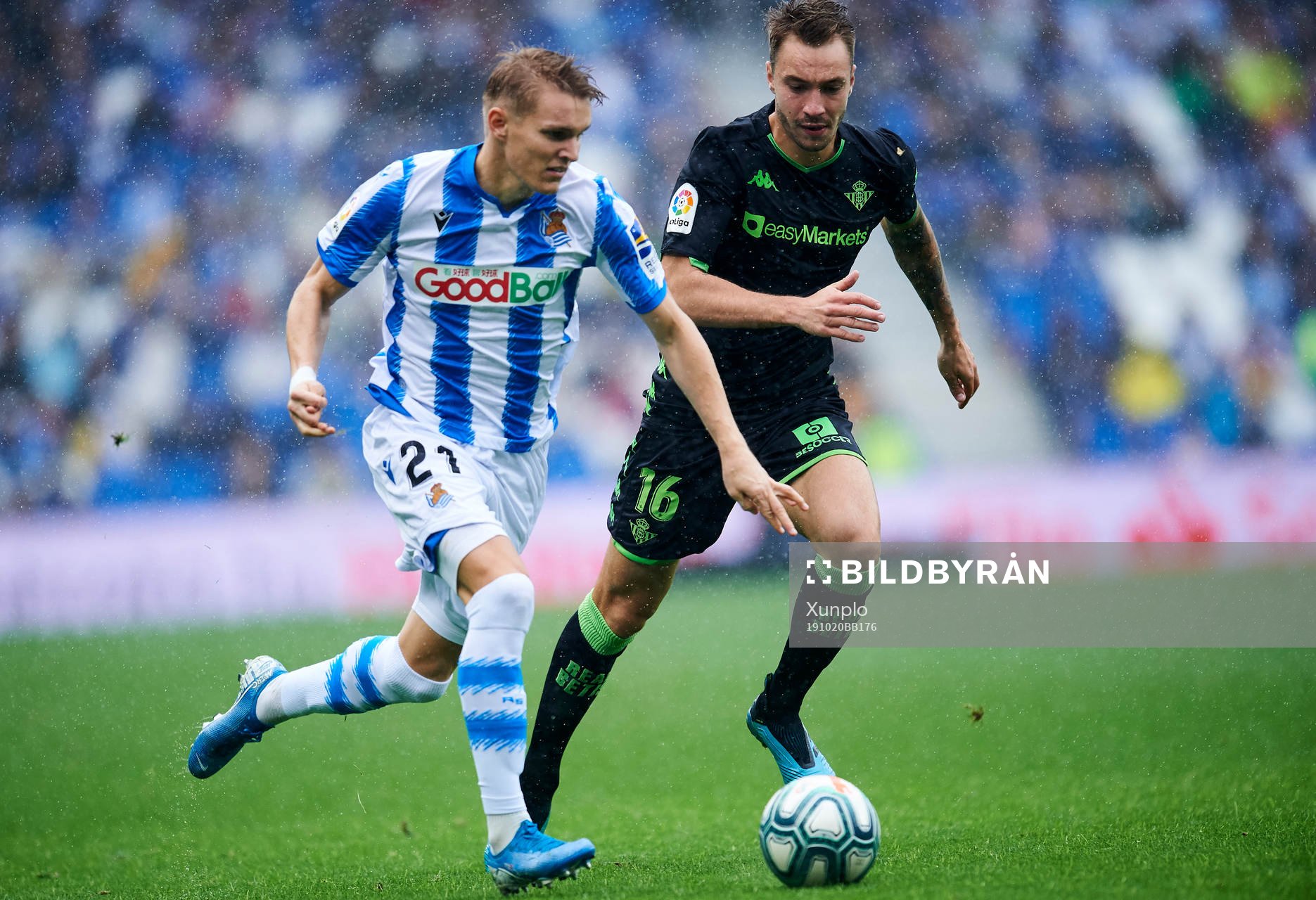 Martin Odegaard of Real Sociedad battles for the ball with