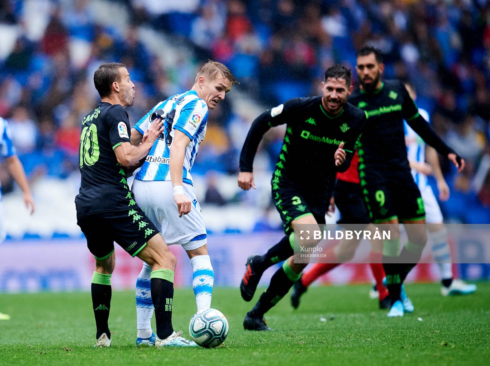 Martin Odegaard of Real Sociedad battles for the ball with