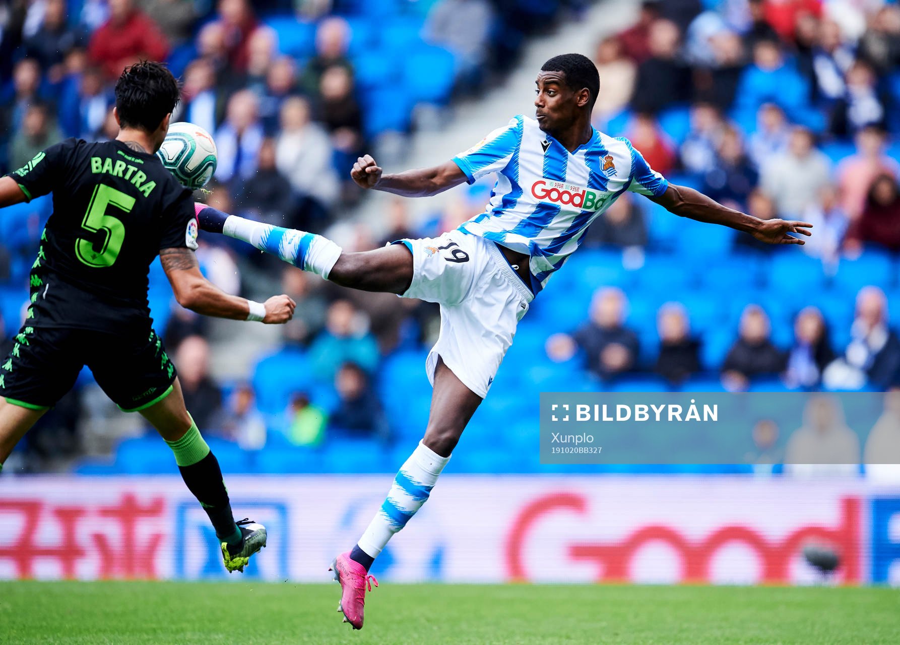 Alexander Isak of Real Sociedad battles for the ball with Marc Bartra of Real Betis Balompie during the La Liga match between Real Sociedad and Real Betis Balompie on October 20, 2019 in San Sebastian, Spain. 