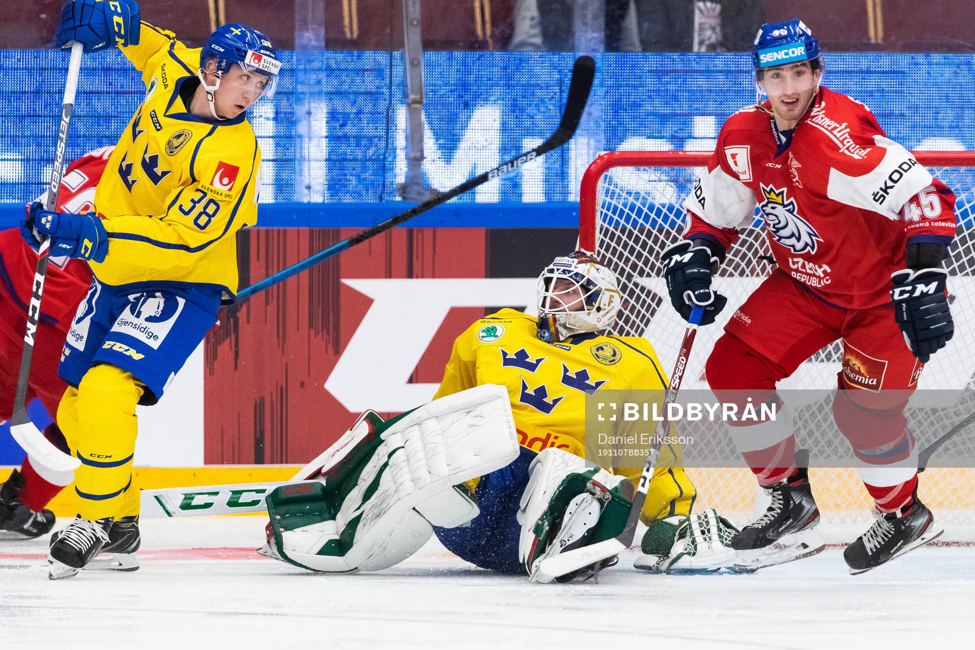 Olle Alsing and goaltender Adam Reideborn of Sweden defend