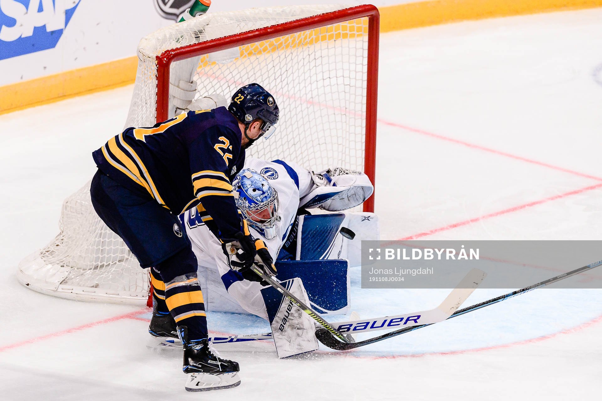 Johan Larsson of Buffalo Sabres and goalkeeper Andrei