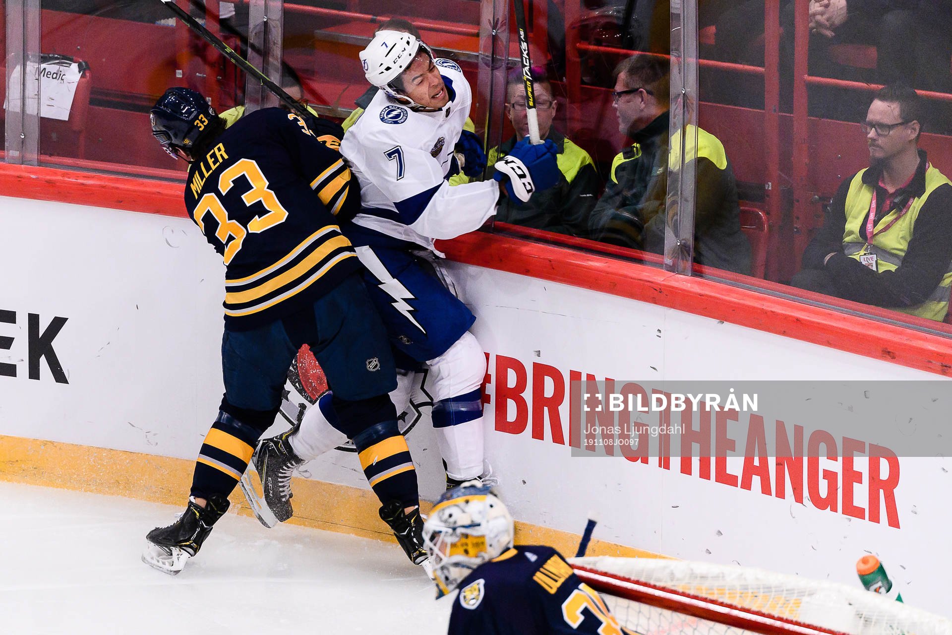 Colin Miller of Buffalo Sabres hits Mathieu Joseph of Tampa