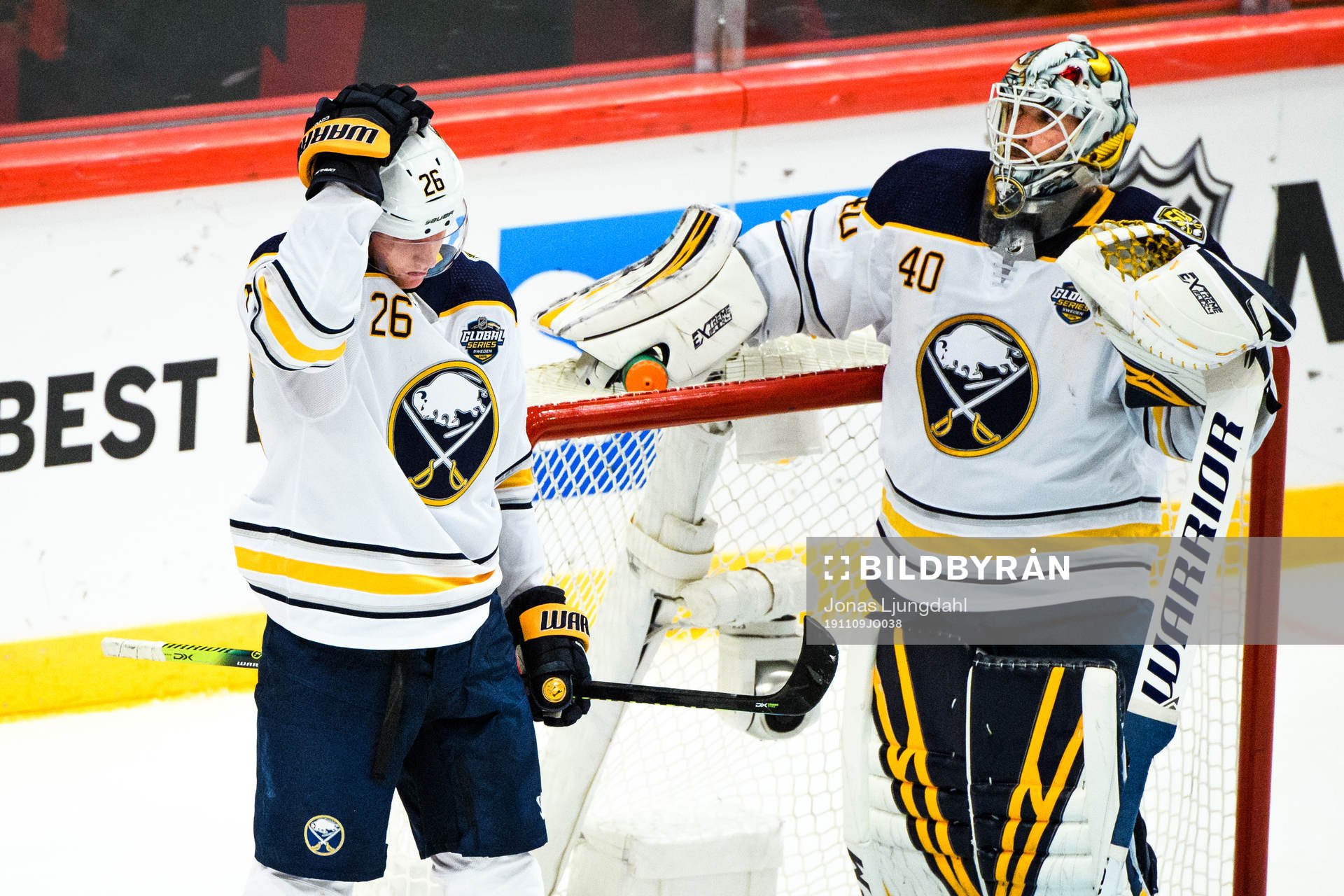 Rasmus Dahlin and goalkeeper Carter Hutton of Buffalo