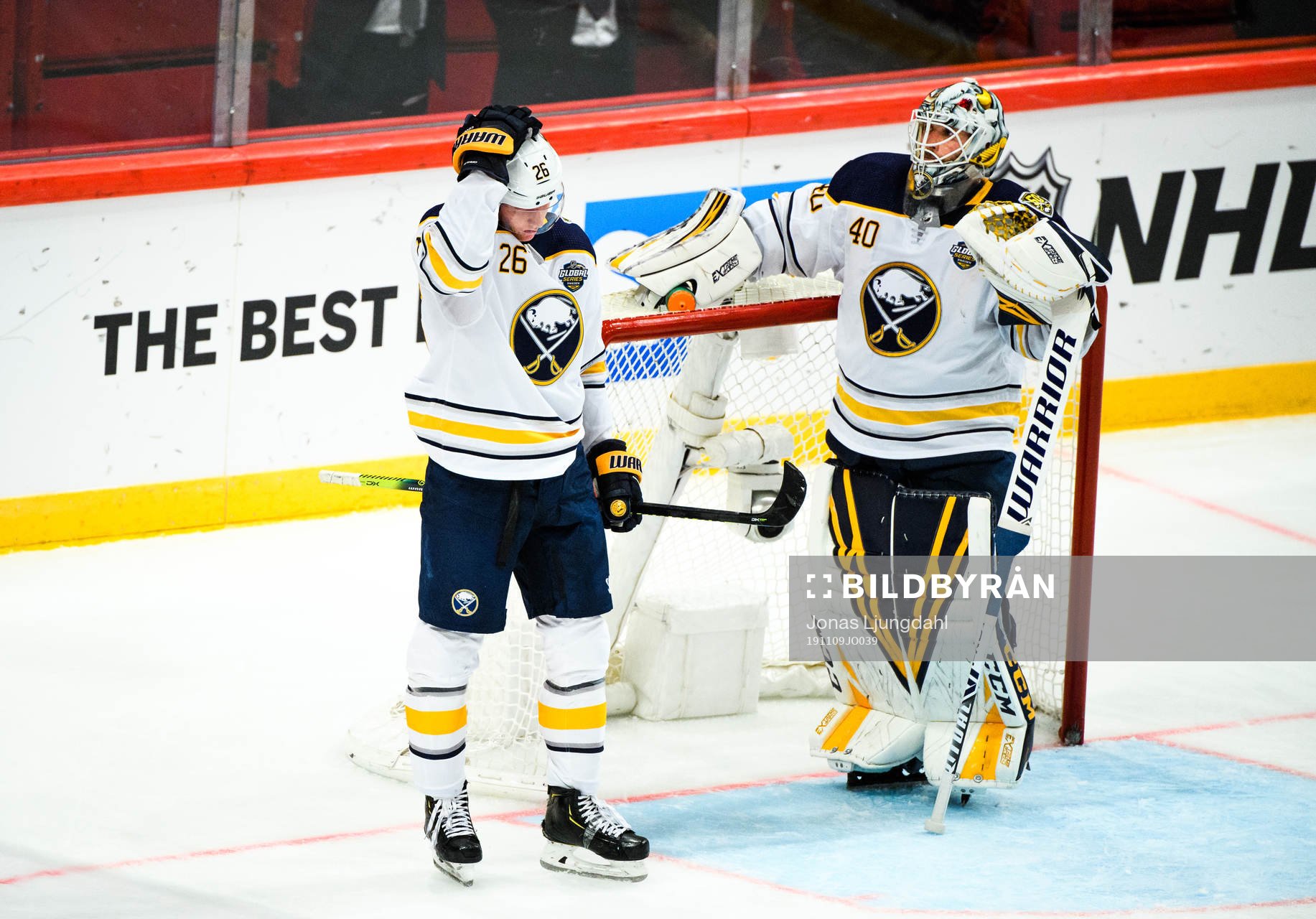 Rasmus Dahlin and goalkeeper Carter Hutton of Buffalo