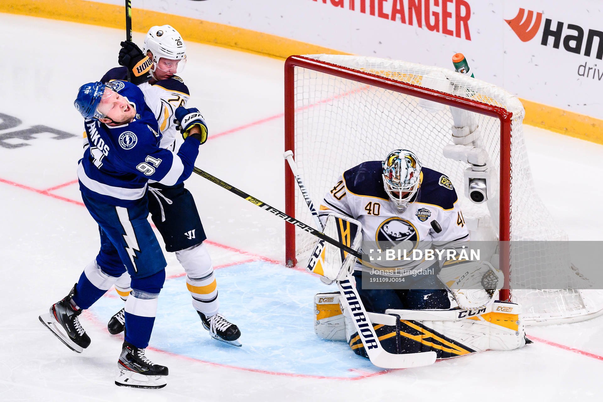 Steven Stamkos gets hit by Rasmus Dahlin of Buffalo Sabres