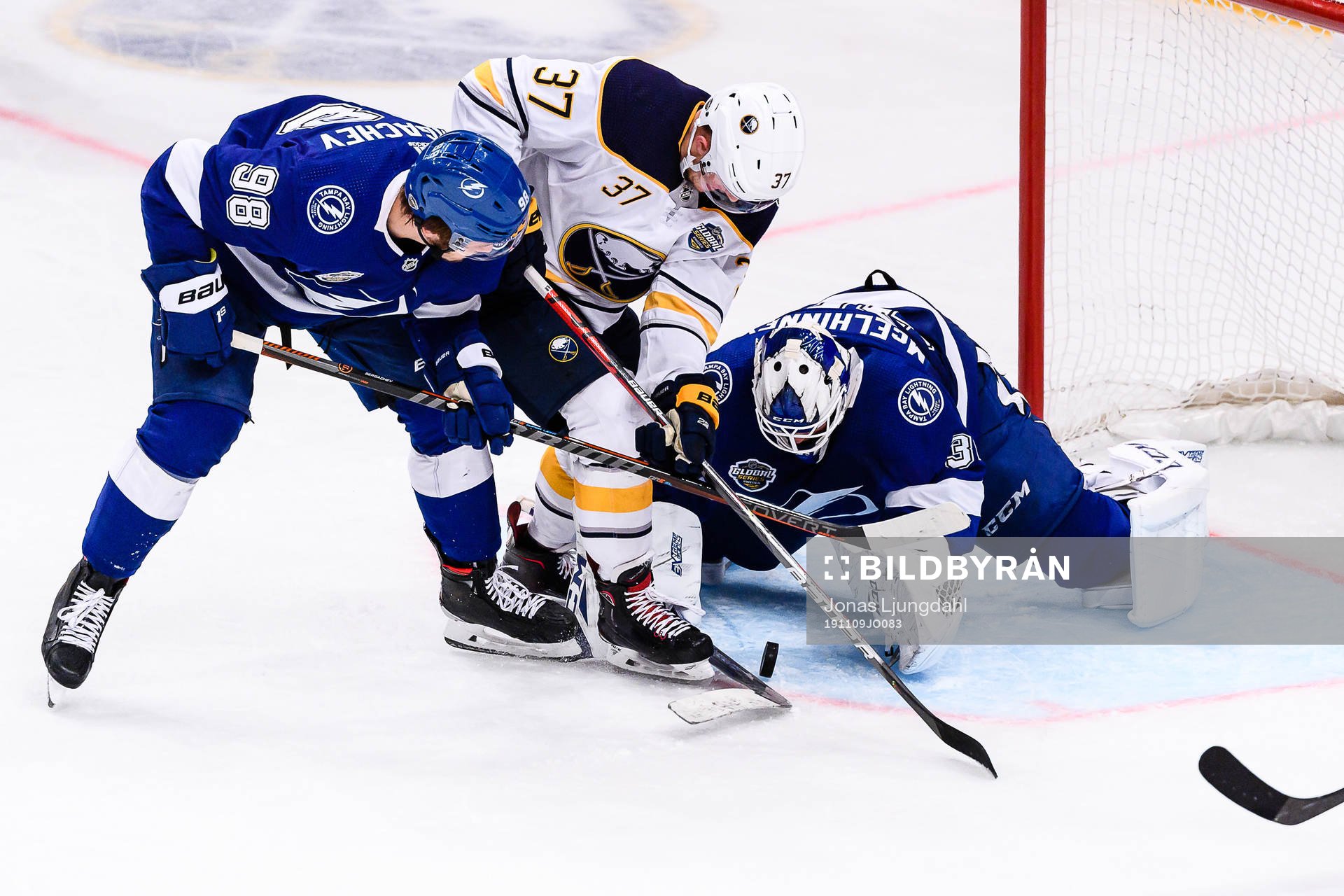Casey Mittelstadtof Buffalo Sabres between Mikhail