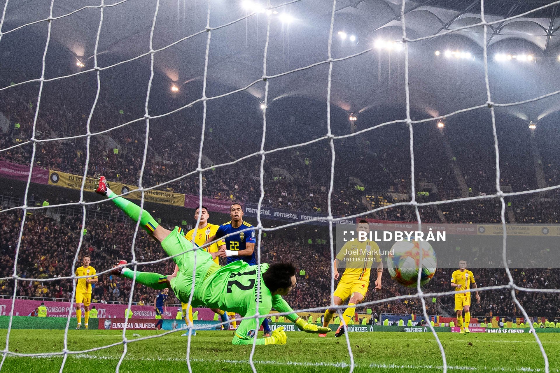 Robin Quaison of Sweden scores 0-2 behind goalkeeper