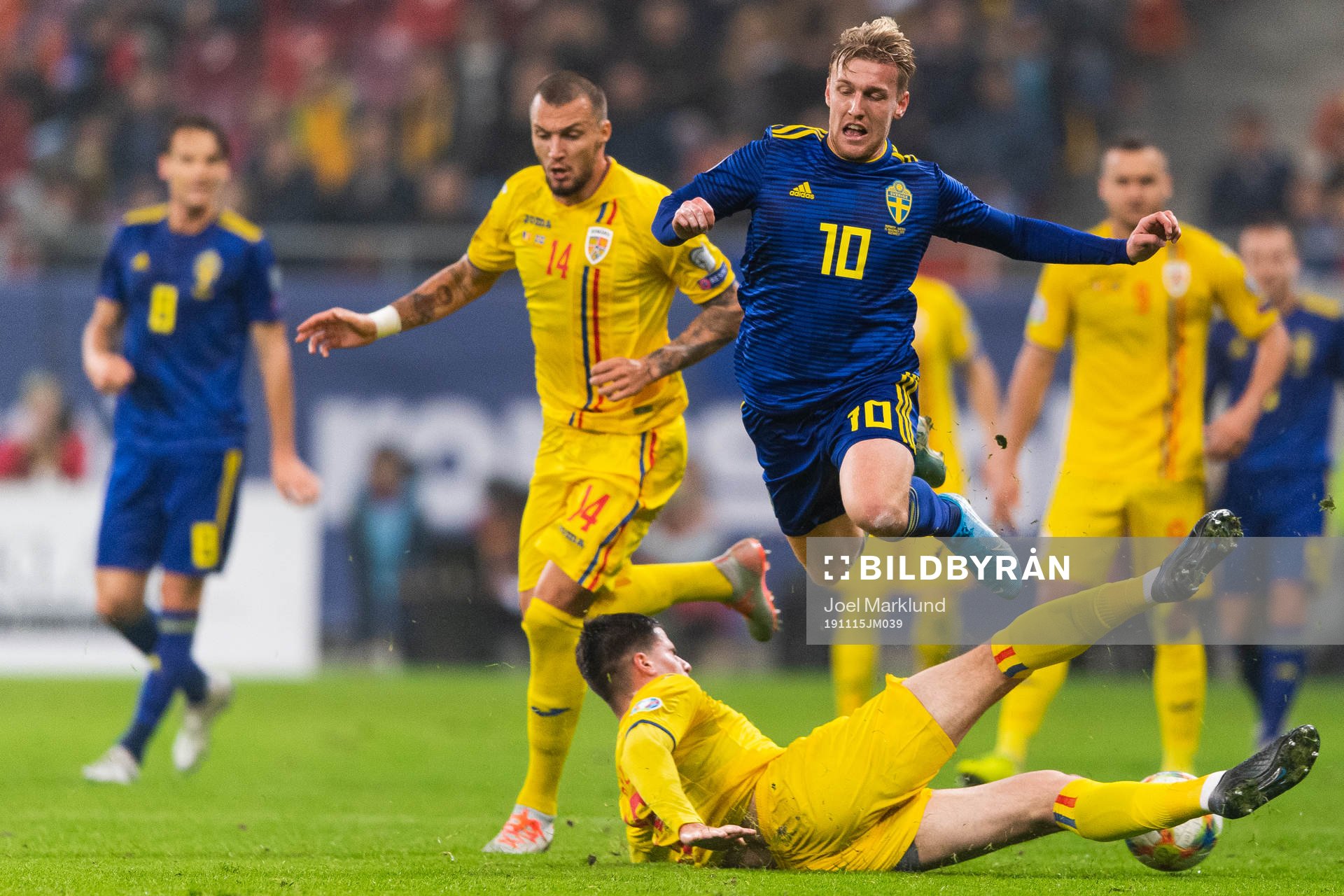 Emil Forsberg of Sweden is tackled by Tudor Baluta of