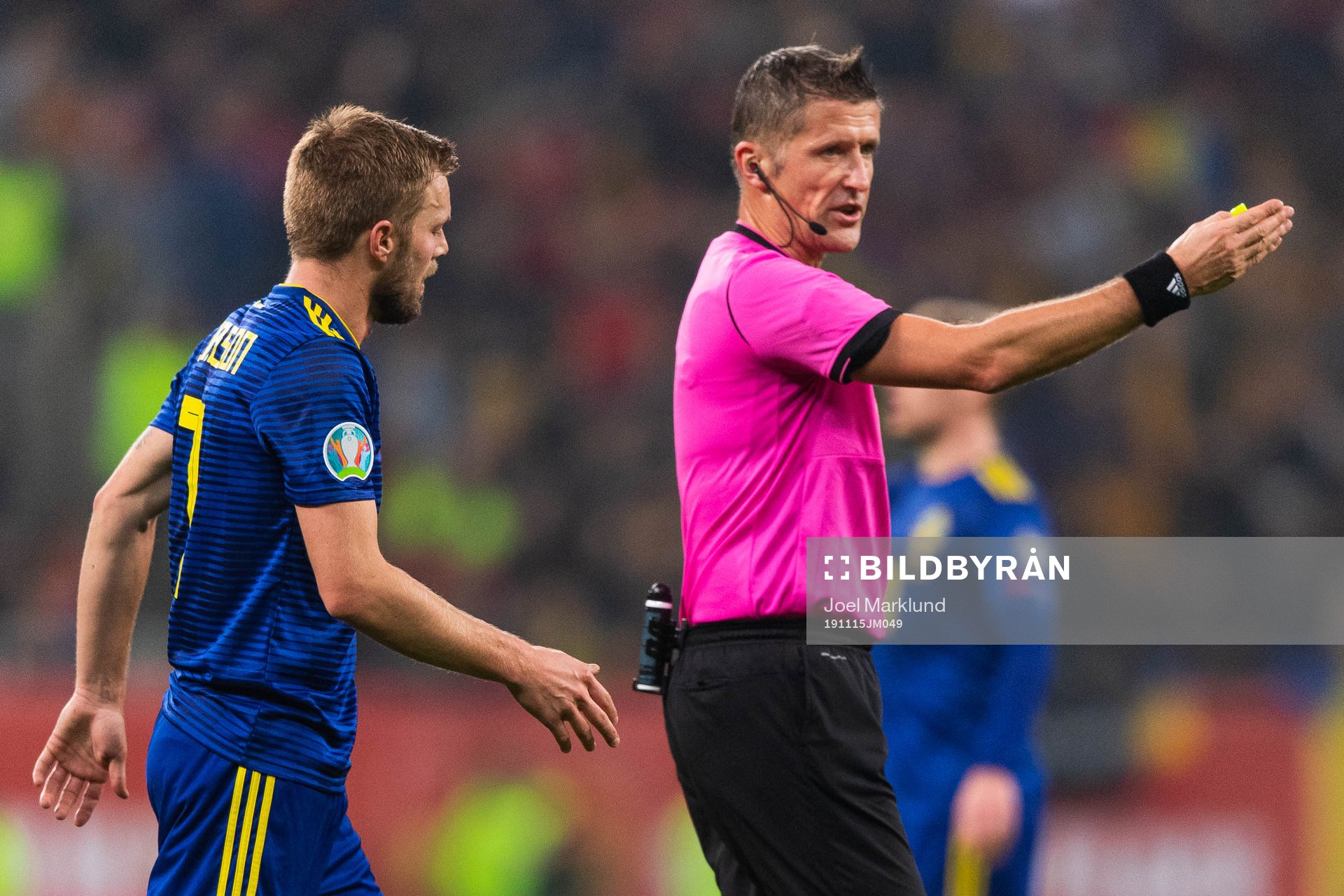 Referee Daniele Orsato signs for Sebastian Larsson of