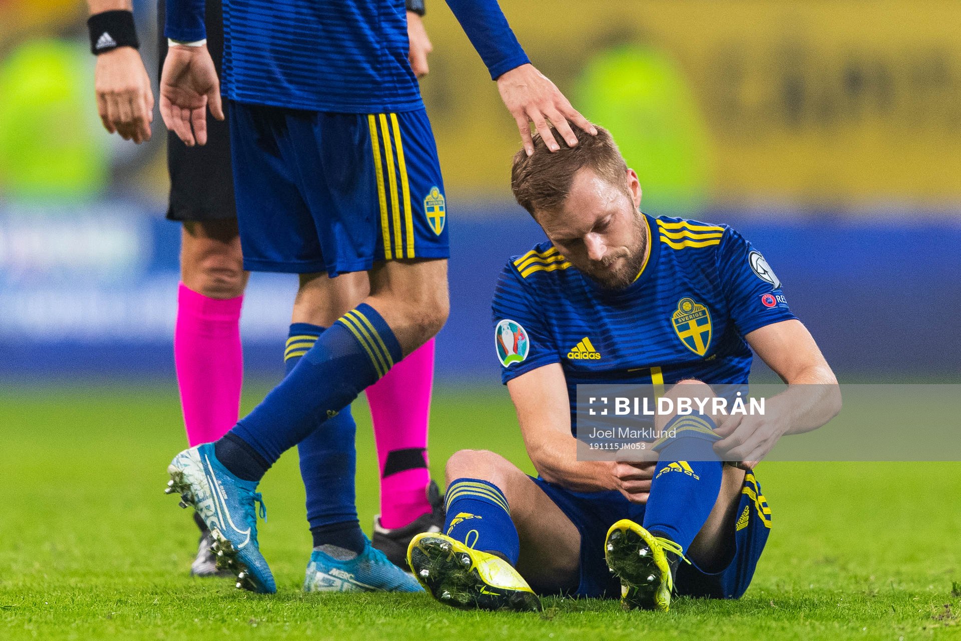 Sebastian Larsson of Sweden sits down injured