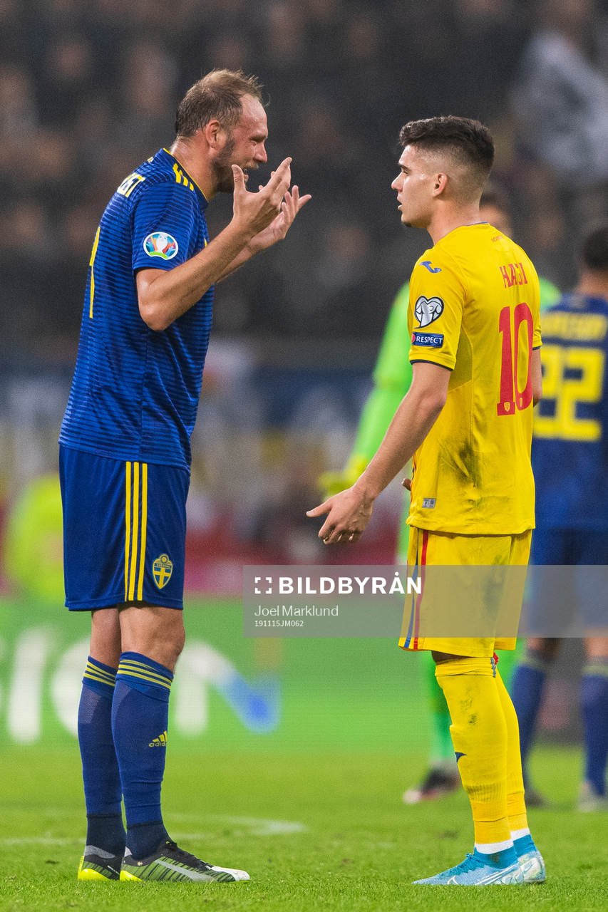 Andreas Granqvist of Sweden and Ianis Hagi of Romania in a