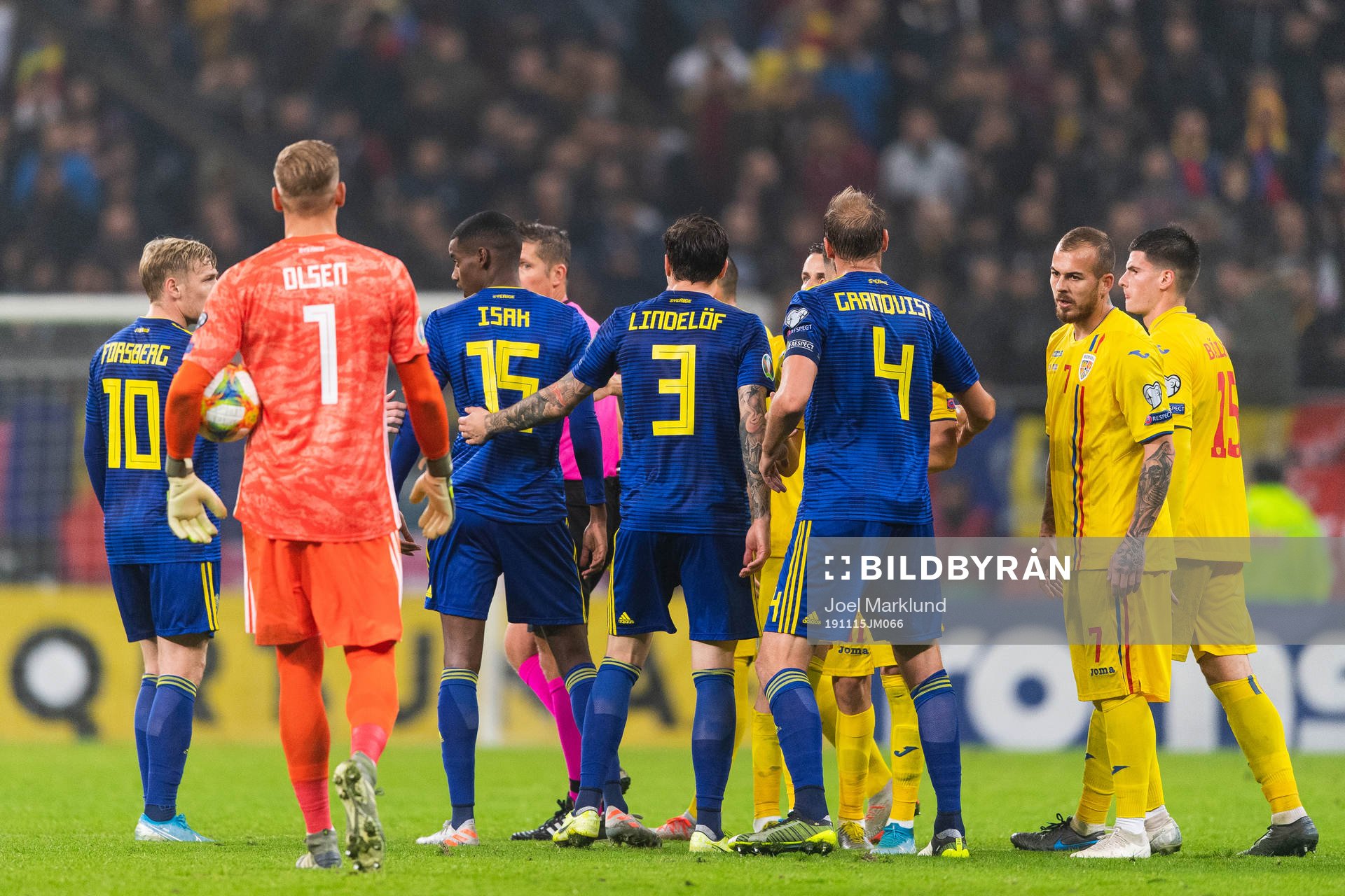 Referee Daniele Orsato in a discussion with Emil Forsberg,