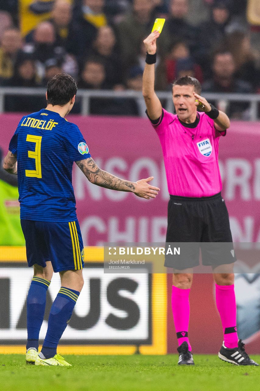 Victor Nilsson Lindelöf of Sweden receives a yellow card