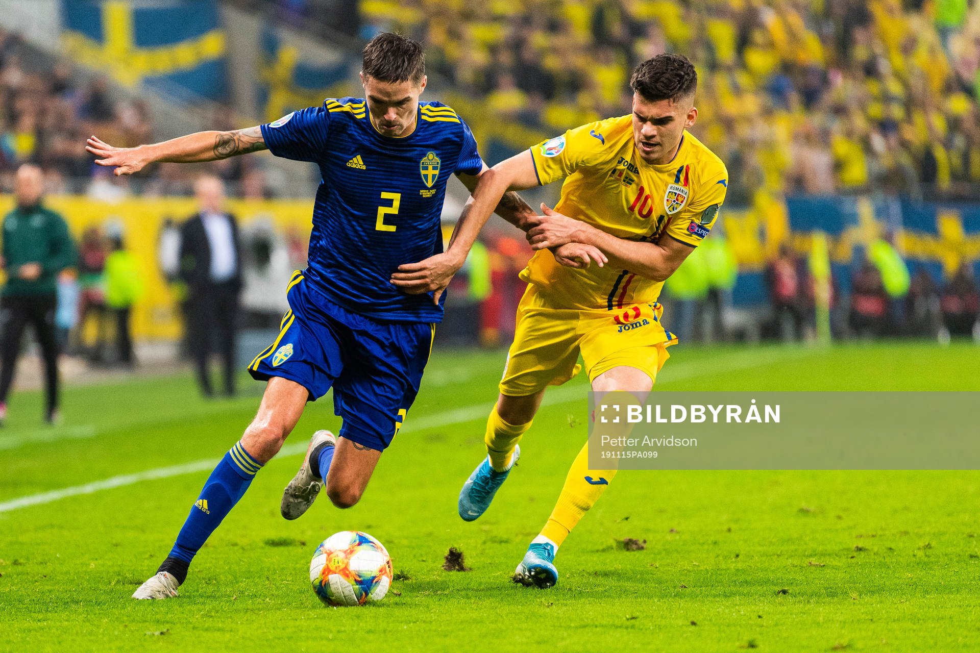 Mikael Lustig of Sweden and Ianis Hagi of Romania compete